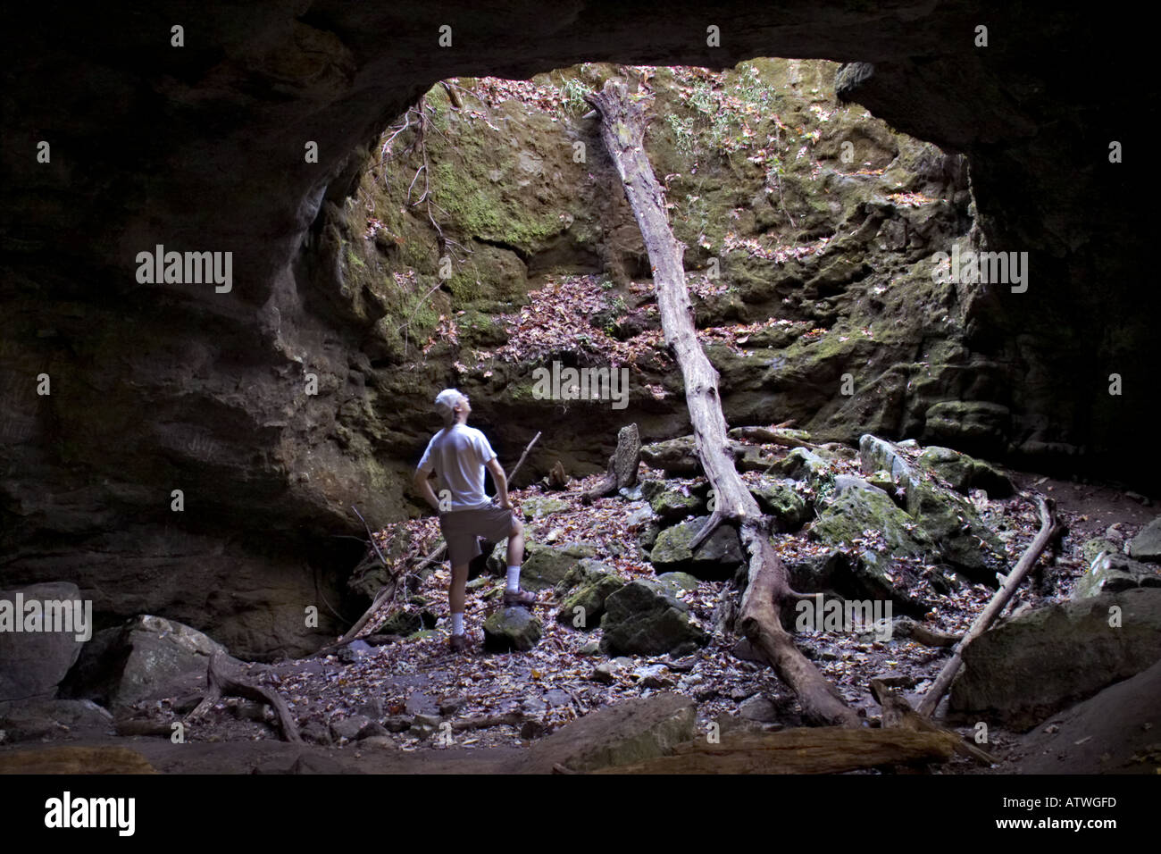 figure inside sinkhole cave Stock Photo