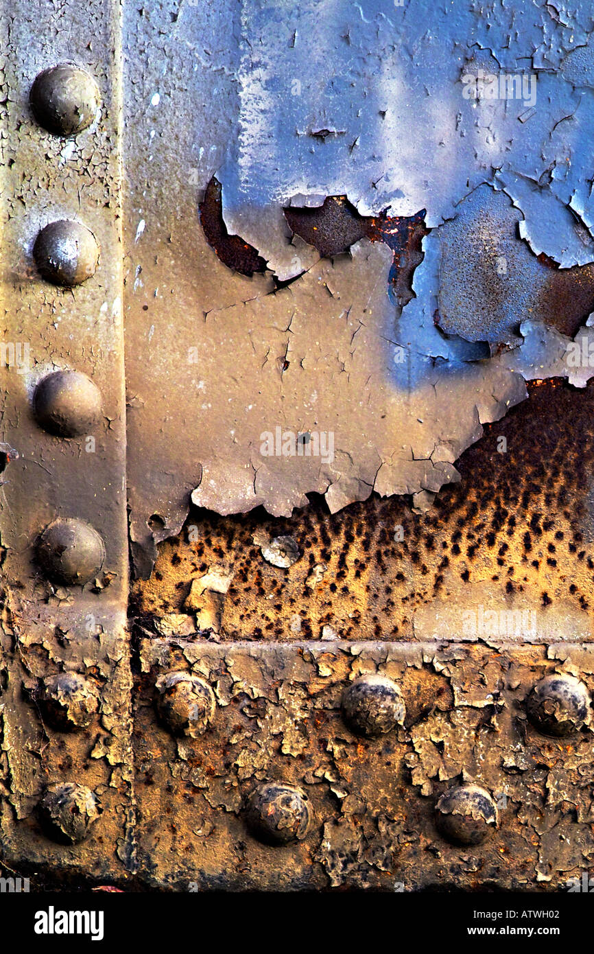 peeling paint and rusted bolts on decaying bridge Stock Photo