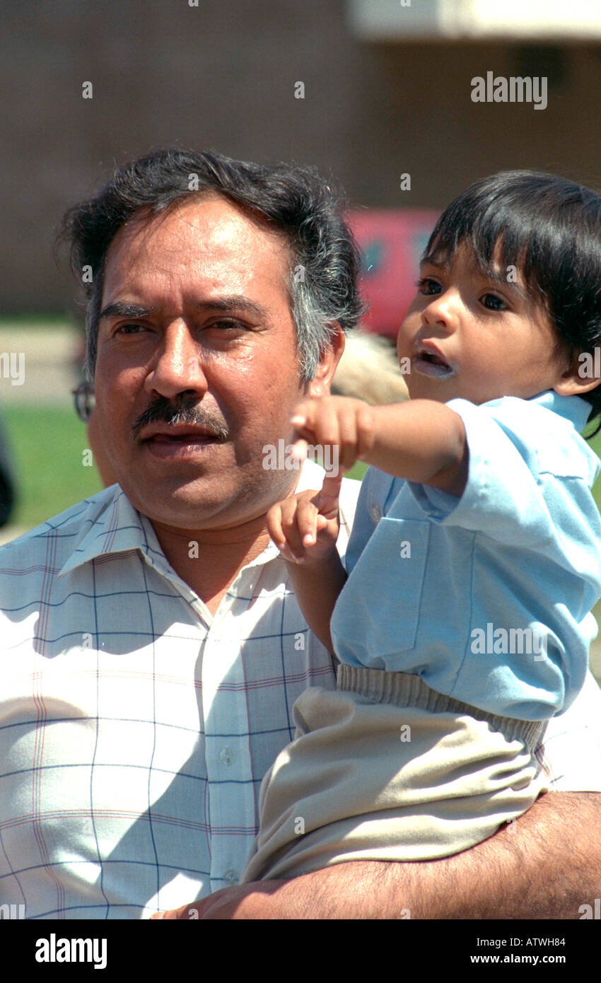Father holding son ages 54 and 2 at Cinco de Mayo Festival. St Paul Minnesota USA Stock Photo
