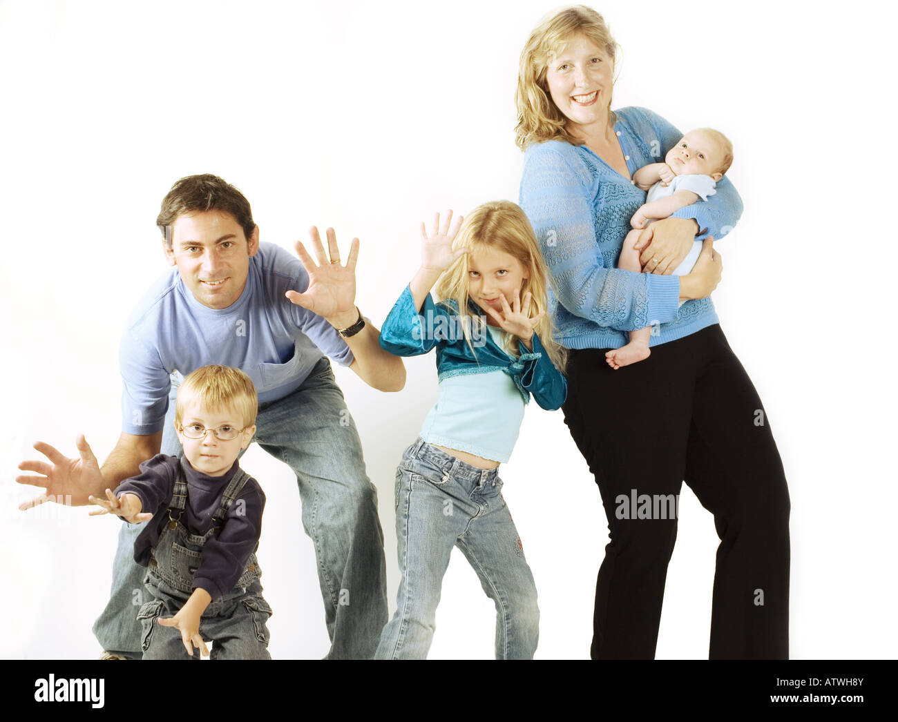 A mother and father act silly with their three kids in the studio Stock Photo