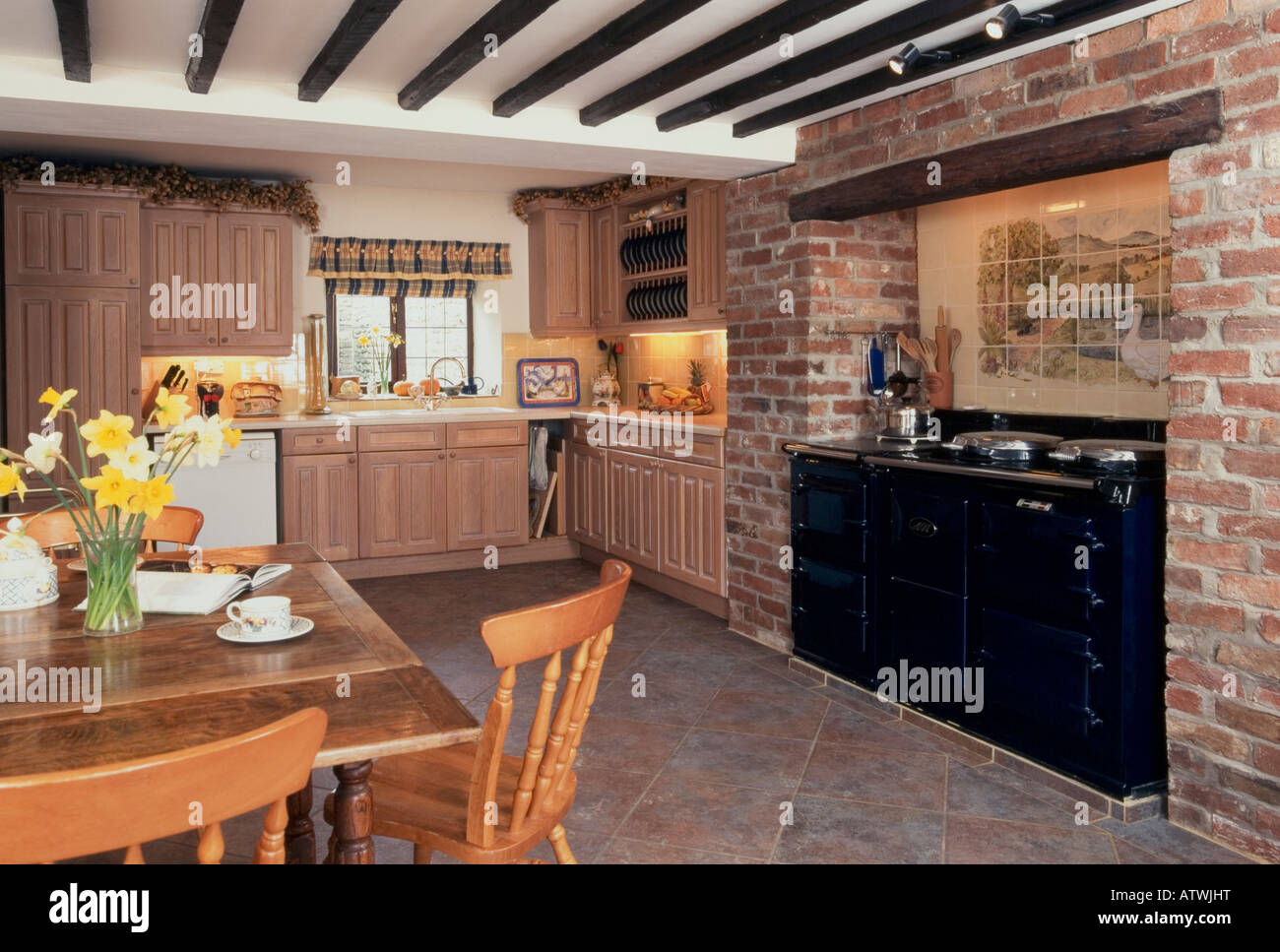 Domestic interior, traditional kitchen diner with aga cooker and beamed ceiling Stock Photo