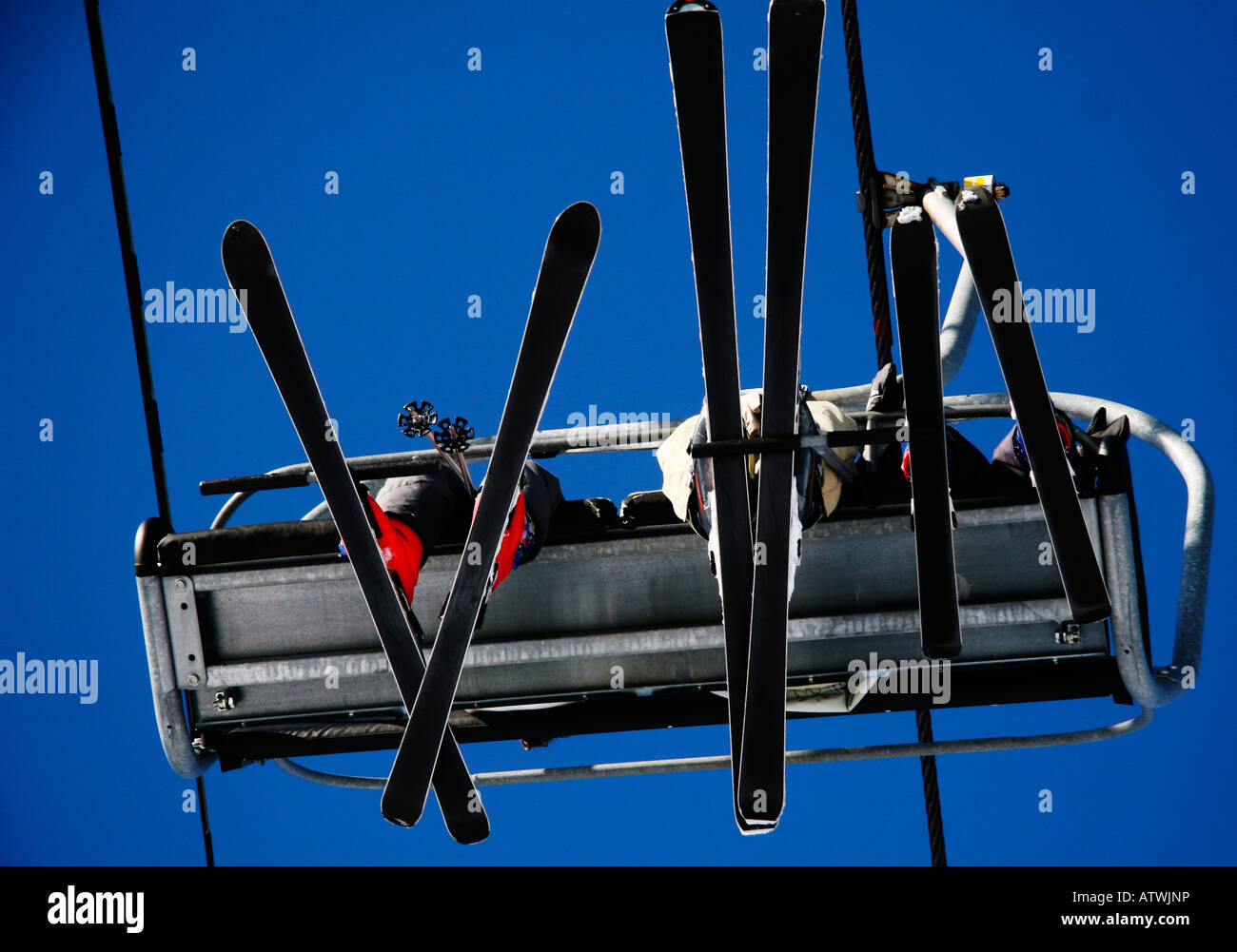 Skiers on a chair lift in the Alps Stock Photo - Alamy
