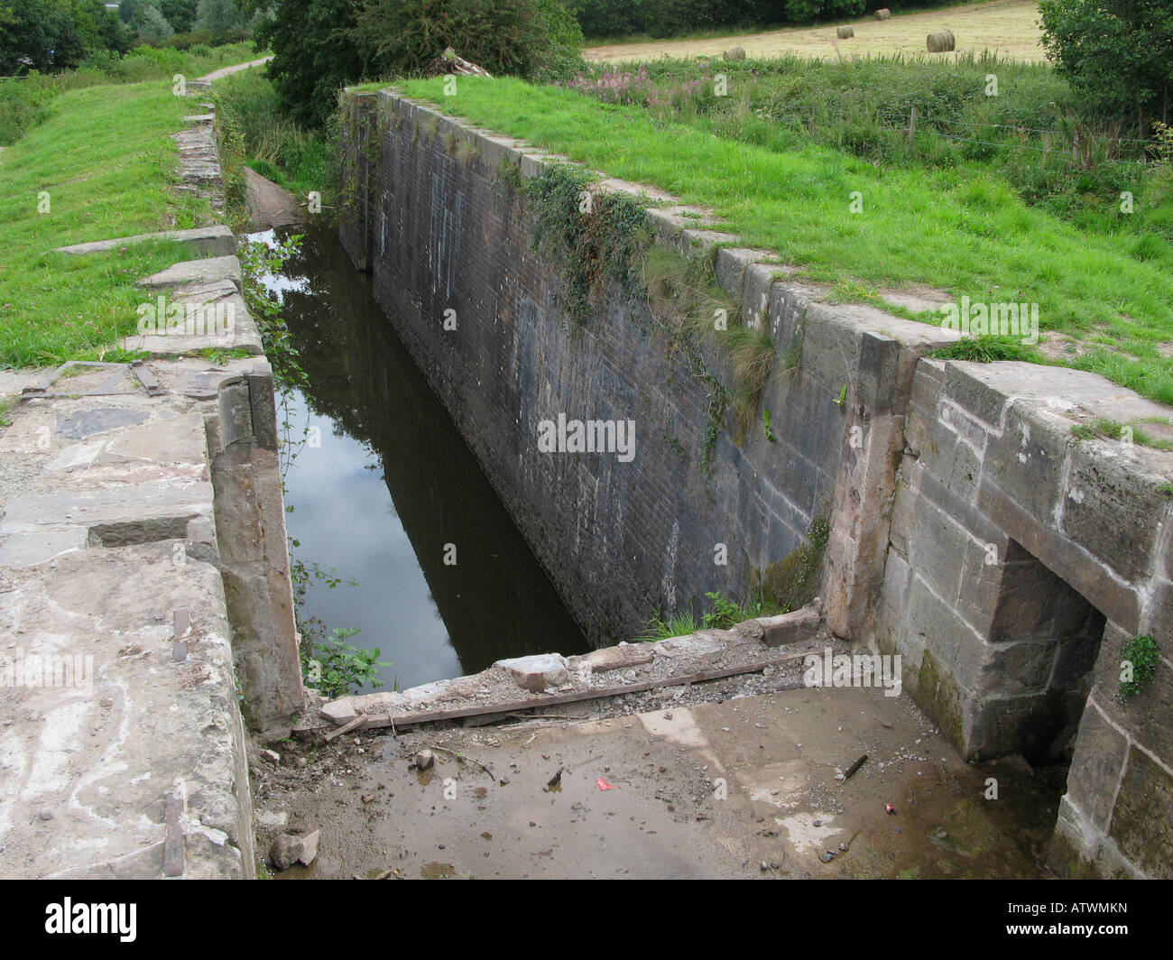 Overgrown derelict canal lock at Newport South Wales UK EU Stock Photo