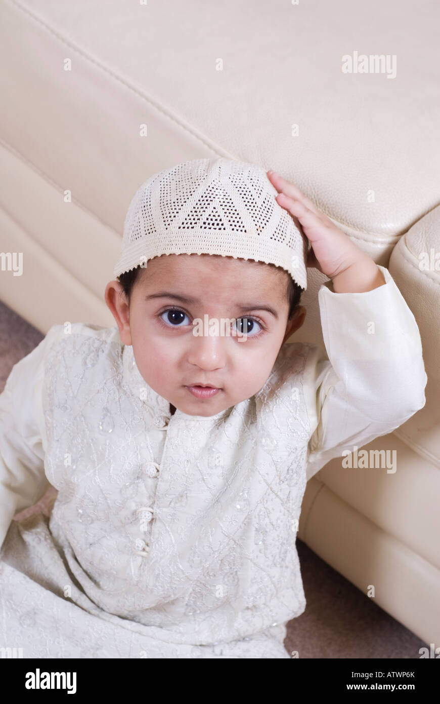 Muslim 1 year old baby hand on head wearing traditional Islamic ...