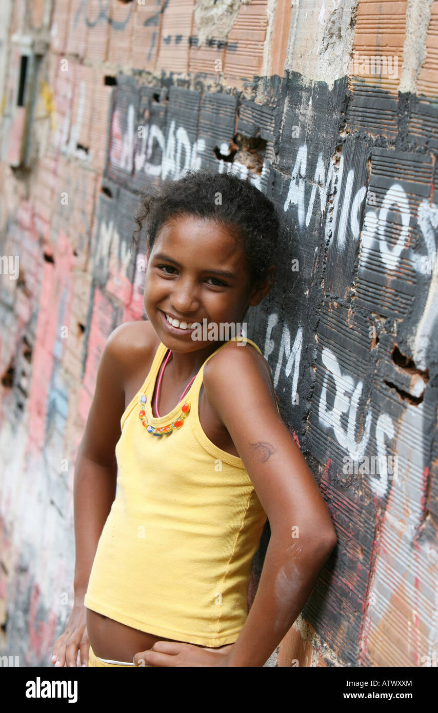 Child in favela community centre painting mural as pat of charity aid project, Rio de Janeiro, Brazil, South America Stock Photo
