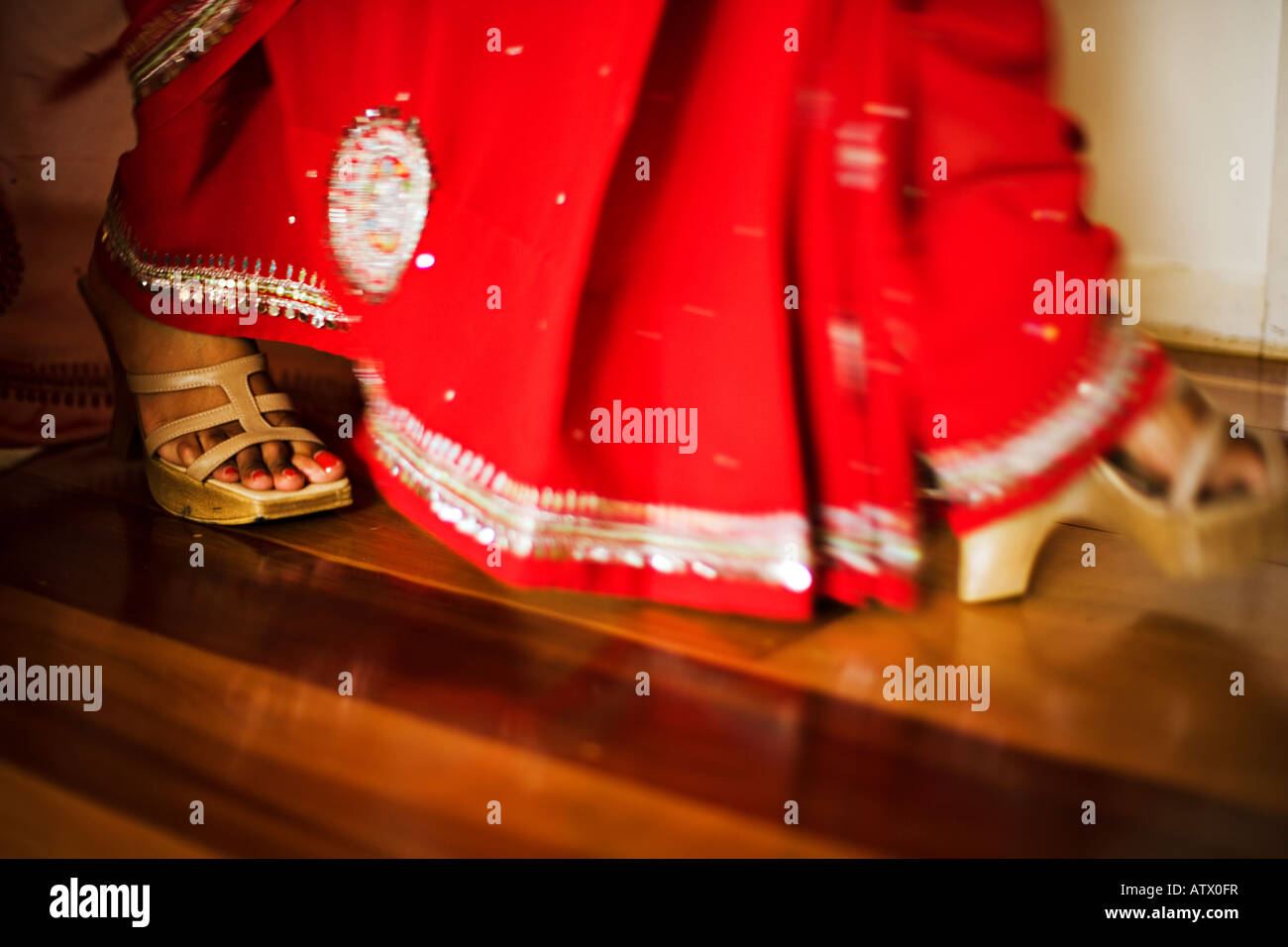 Feet of a woman in red sari Stock Photo