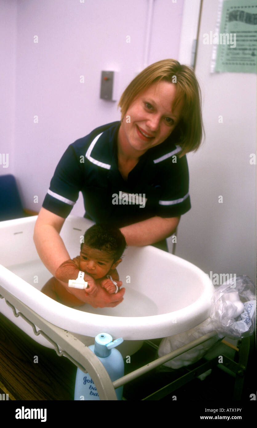 Midwife bathing newborn baby at Hospital London Stock Photo Alamy