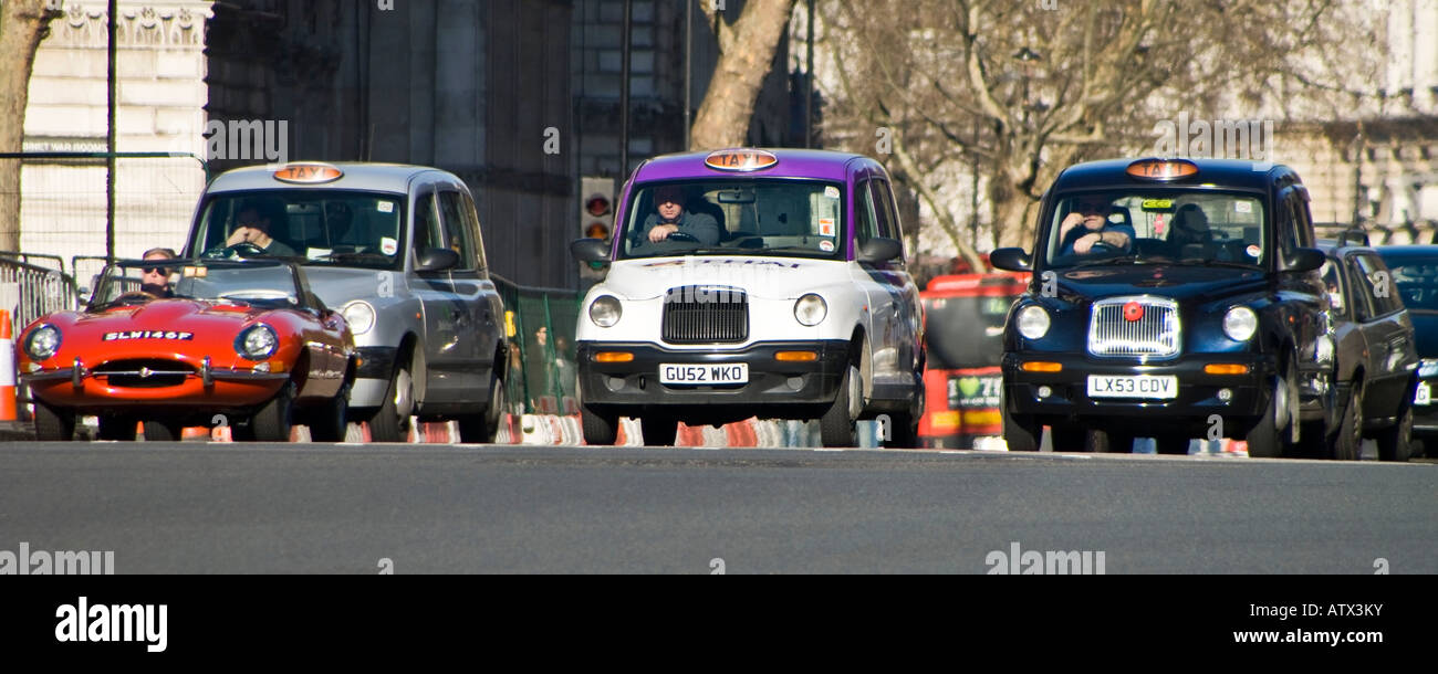 Taxi waiting at the traffic light in front of Houses of Parliament ...
