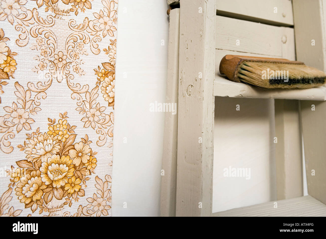 Retro style shot of handing wallpaper. VIntage wallpaper, stepladders and wallpaper brush Stock Photo