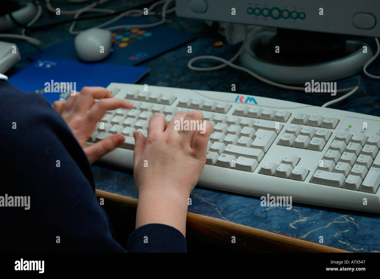 Learning keyboard skills in IT suite in mainstream school Stock Photo
