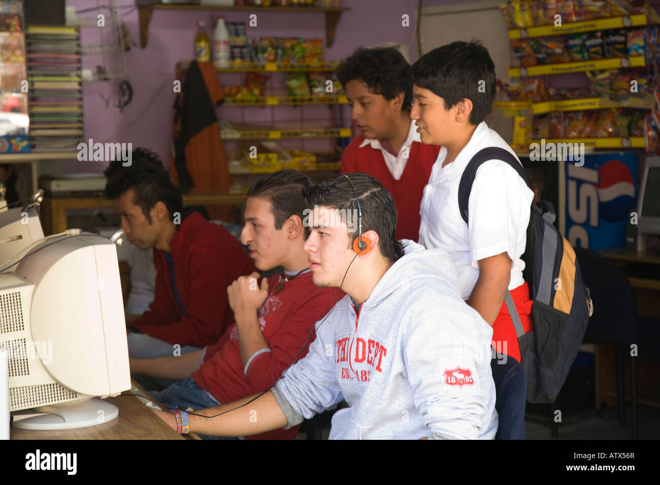 MEXICO Guanajuato Five Mexican boys and teens playing and watching computer games in corner grocery store Stock Photo