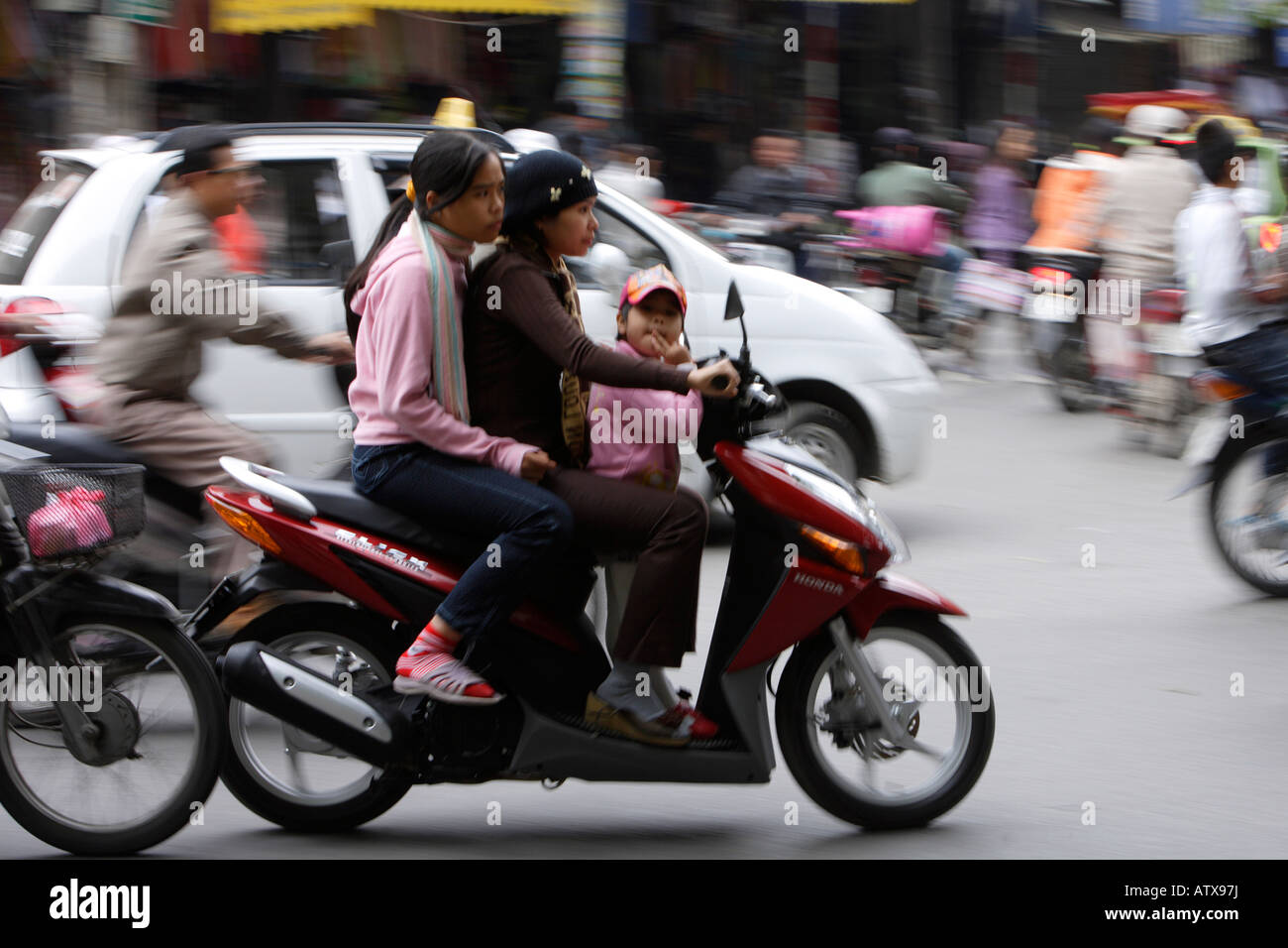 Family on Scooter in Traffic Hanoi North Vietnam Stock Photo