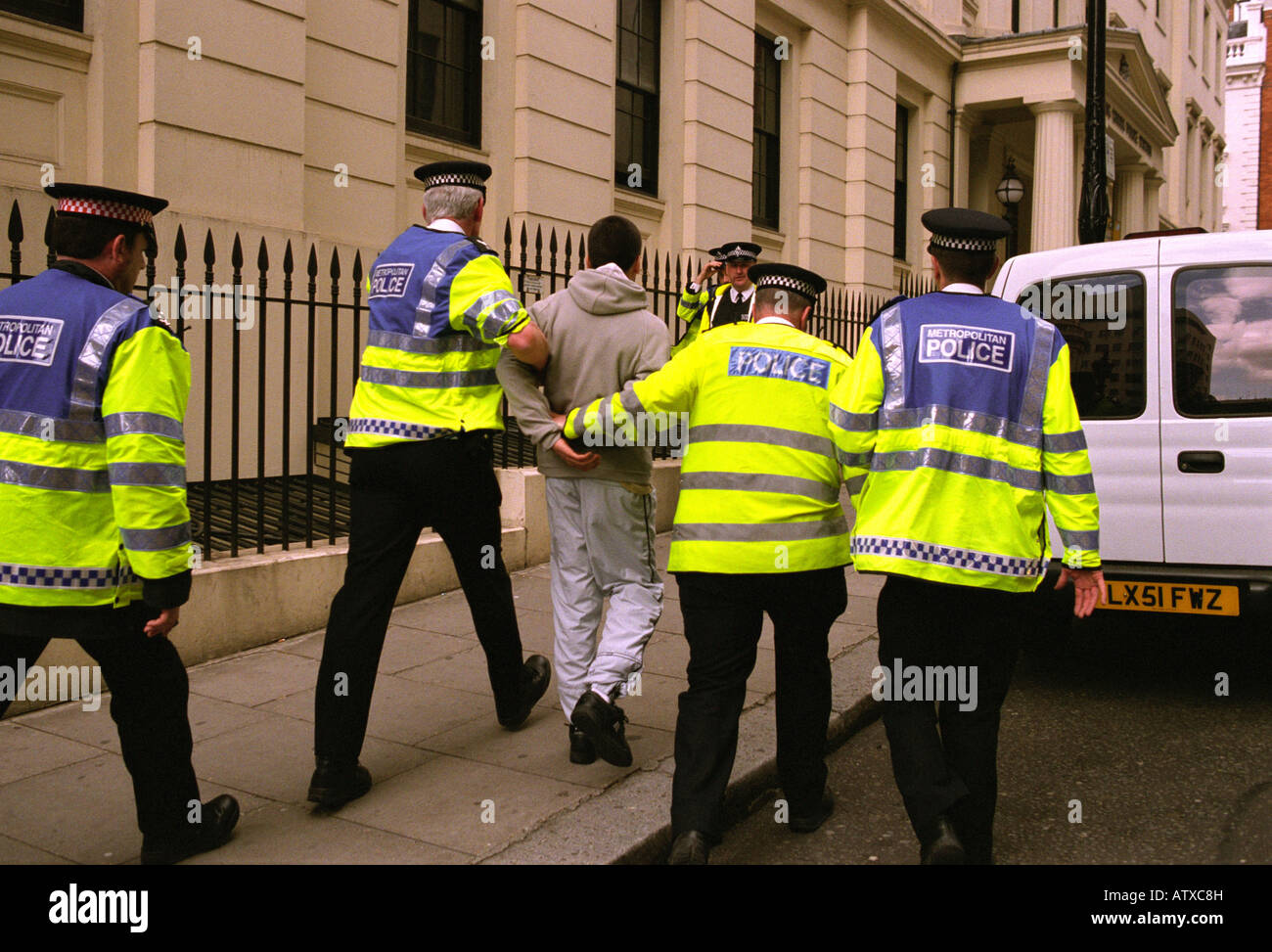 Police officers arresting a young man at a demonstration in central London,  Mayday 2003. Stock Photo