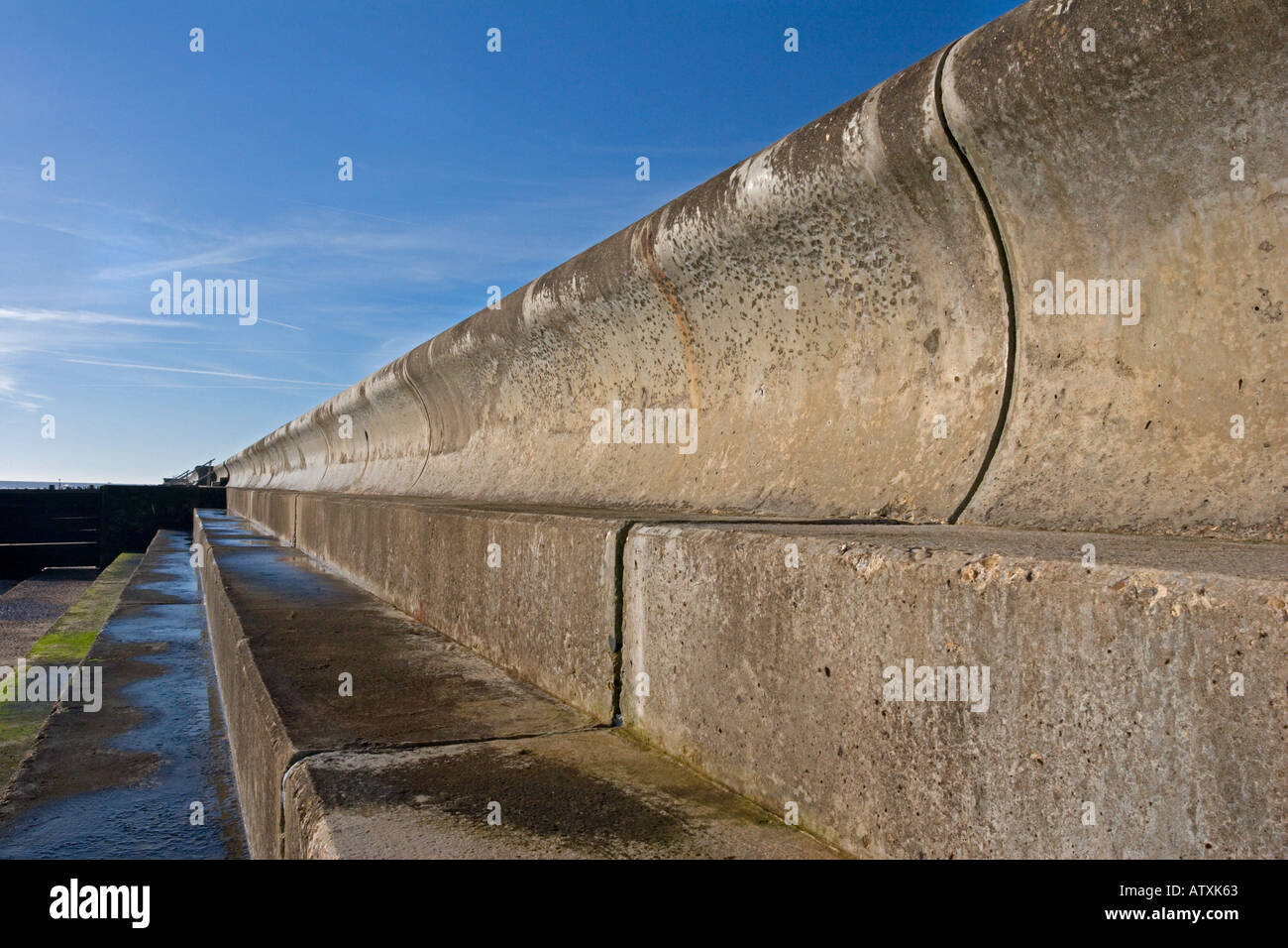 Frinton on sea beach seawall defense, curved and made of concrete Stock Photo