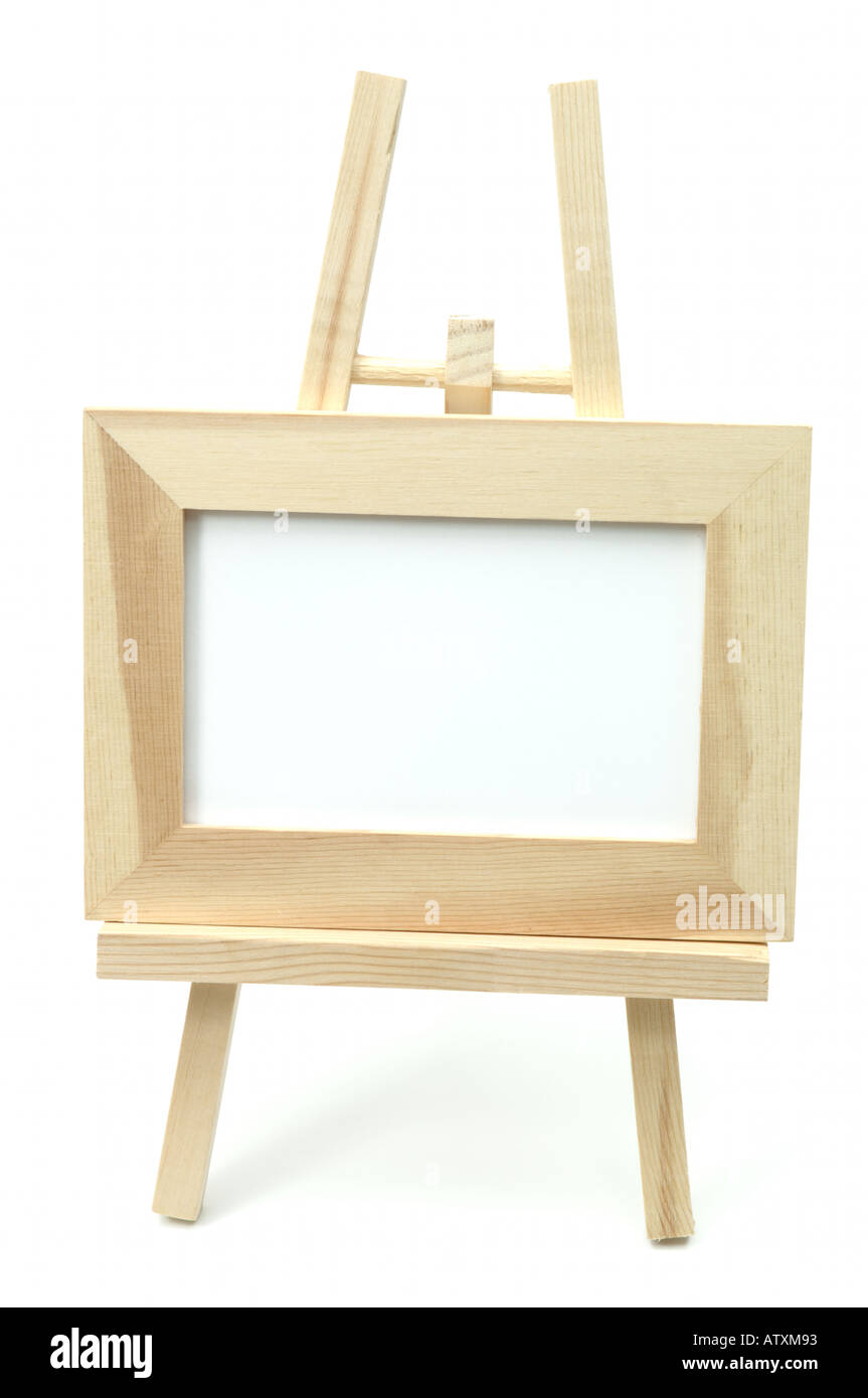 Wooden easel with white framed board on white background Stock Photo