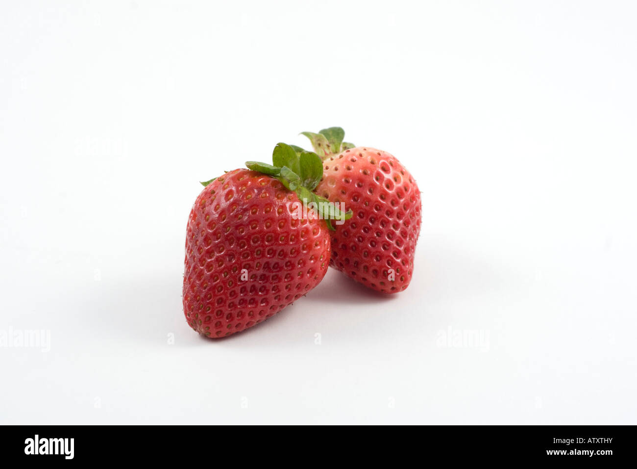 Two fresh red ripe strawberries on white background Stock Photo - Alamy