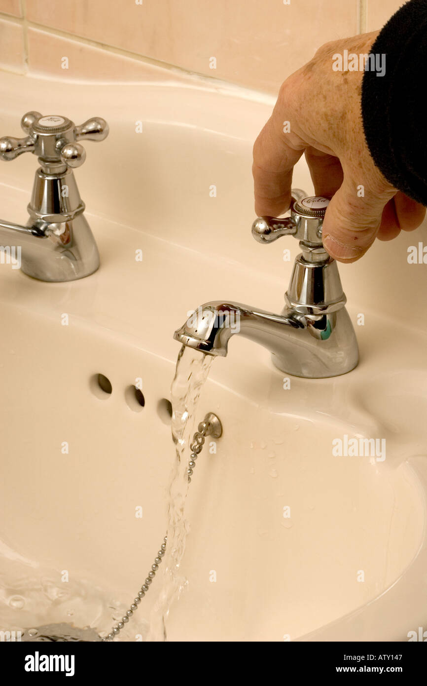 Hand turning tap off hires stock photography and images Alamy