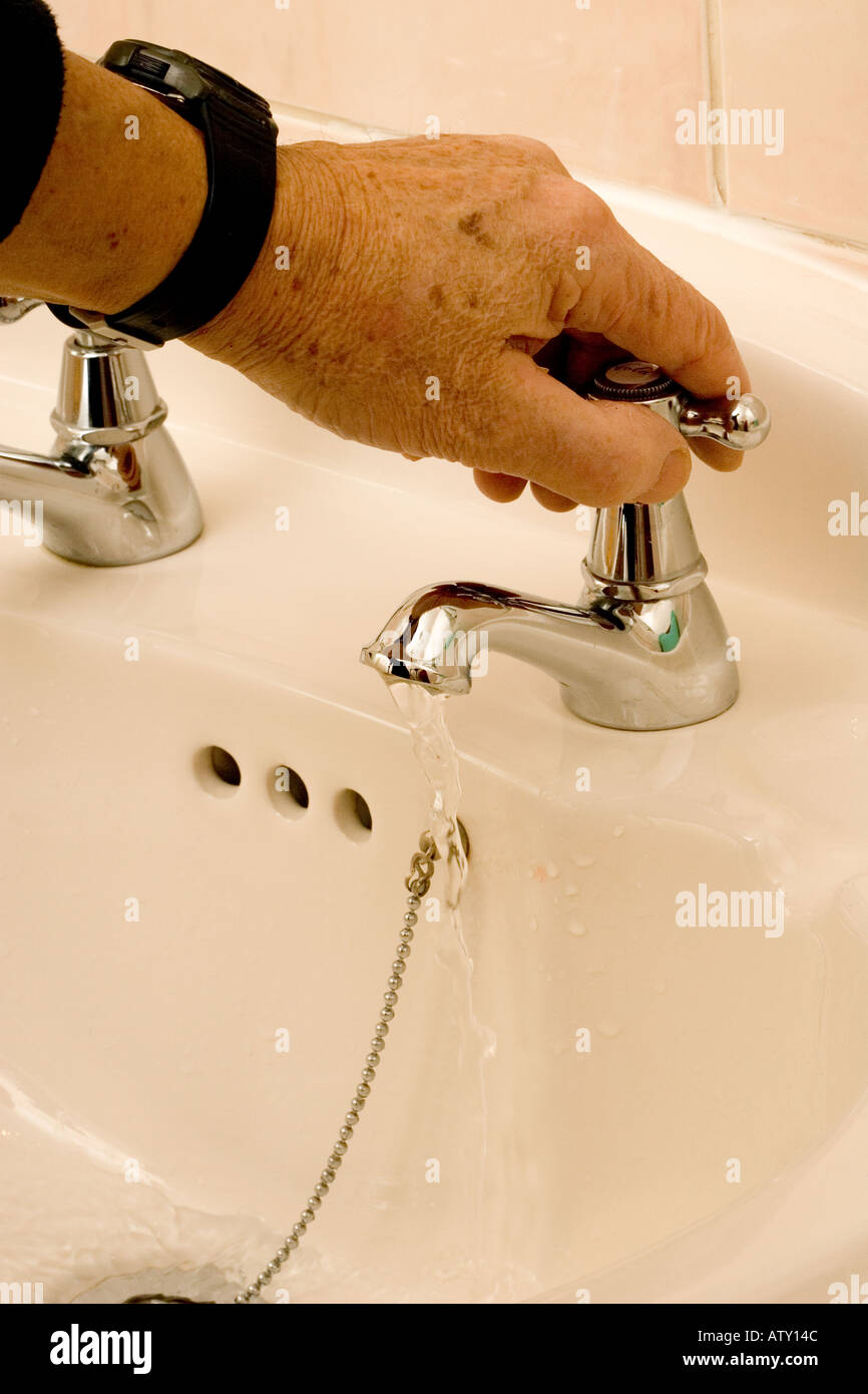 Hand turning tap off hires stock photography and images Alamy