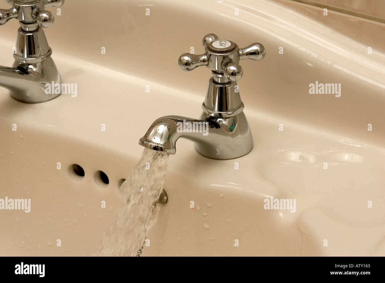 Bathroom tap left running Stock Photo Alamy