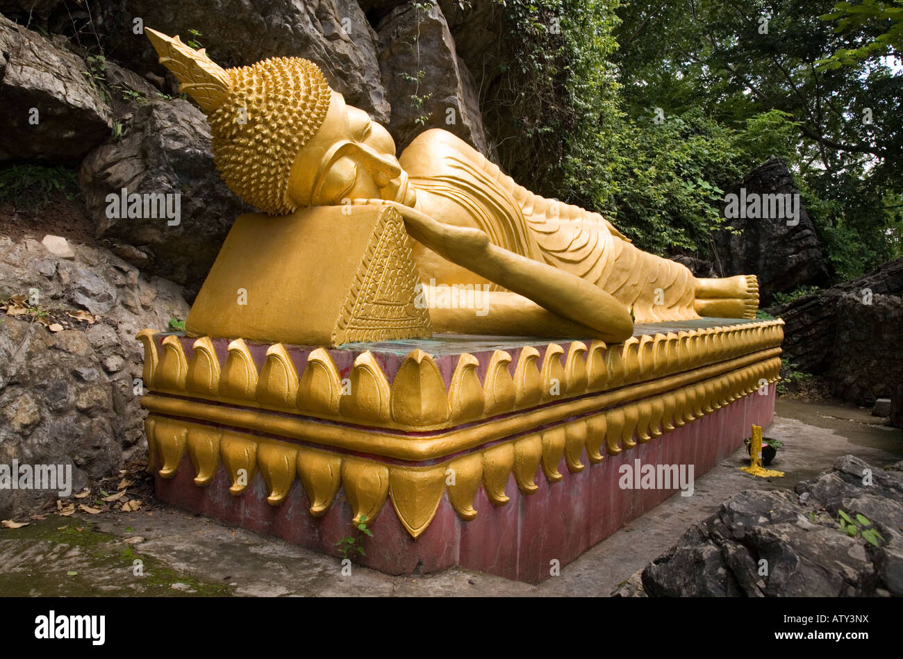 Reclining golden Buddha statue of Wat Prabang Phoutthalawanh on Mount Phu Si, Luang Prabang. Laos. Stock Photo