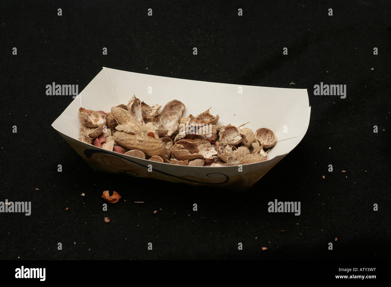 Paper tray of peanut shells after consuming the nuts Stock Photo