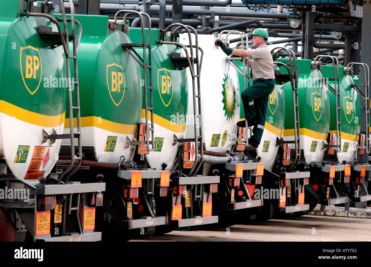 BP tankers lined up for inspecton with BP employee checking them over. Stock Photo