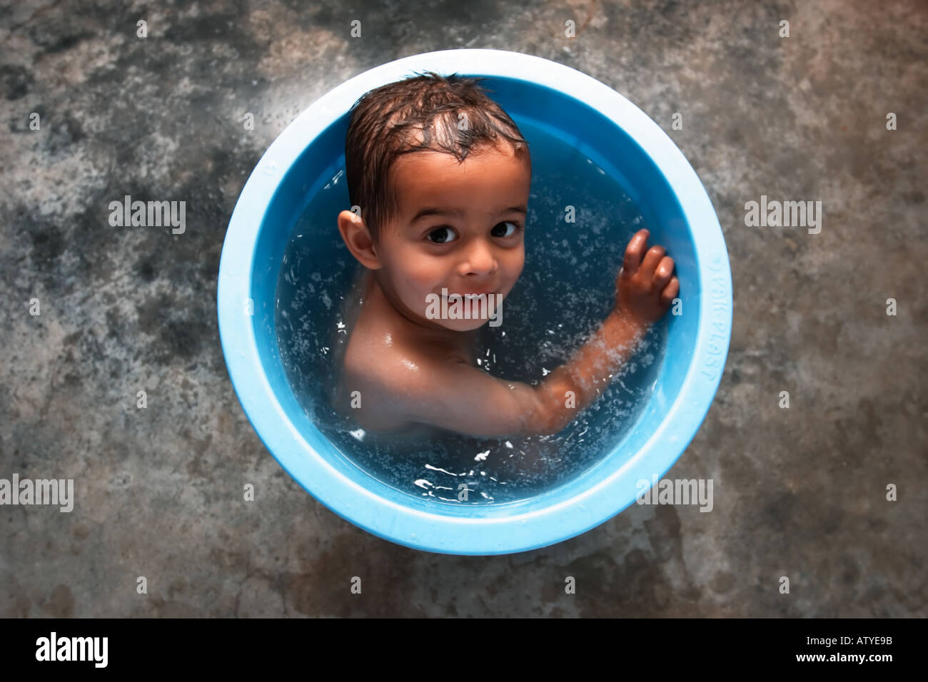 Boy at bathtime in Pakistan of mixed race English father and Pakistani mother Stock Photo