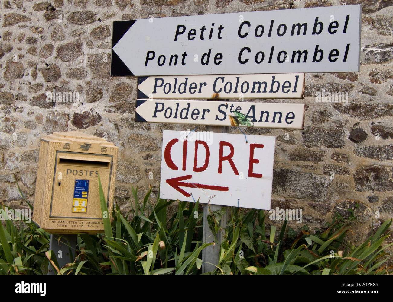 Sign posts and post box in the village Stock Photo - Alamy