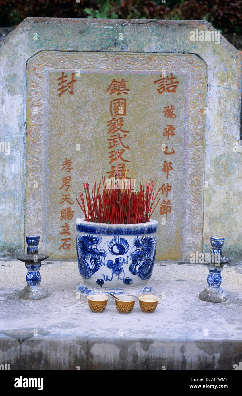 Incense in a pot and one burning in a little dish at Ha Tien Mac Tombs Stock Photo