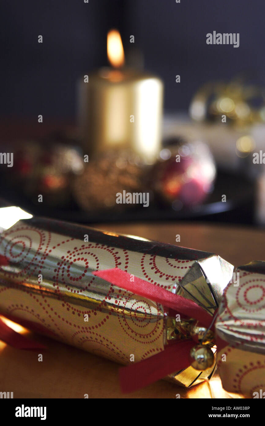 christmas cracker with candle in background Stock Photo