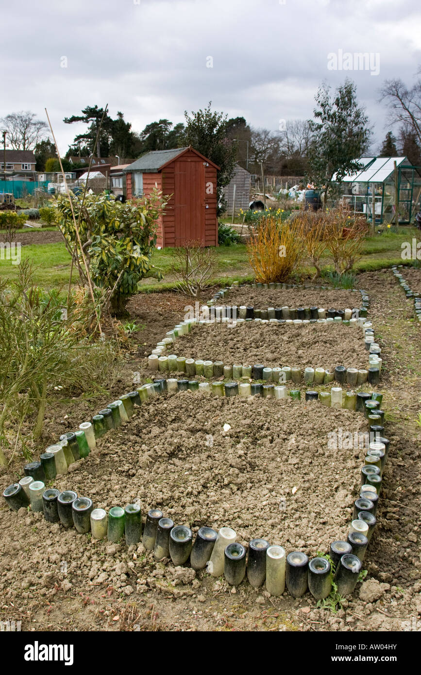 Green bottles arranged on an garden allotment Stock Photo