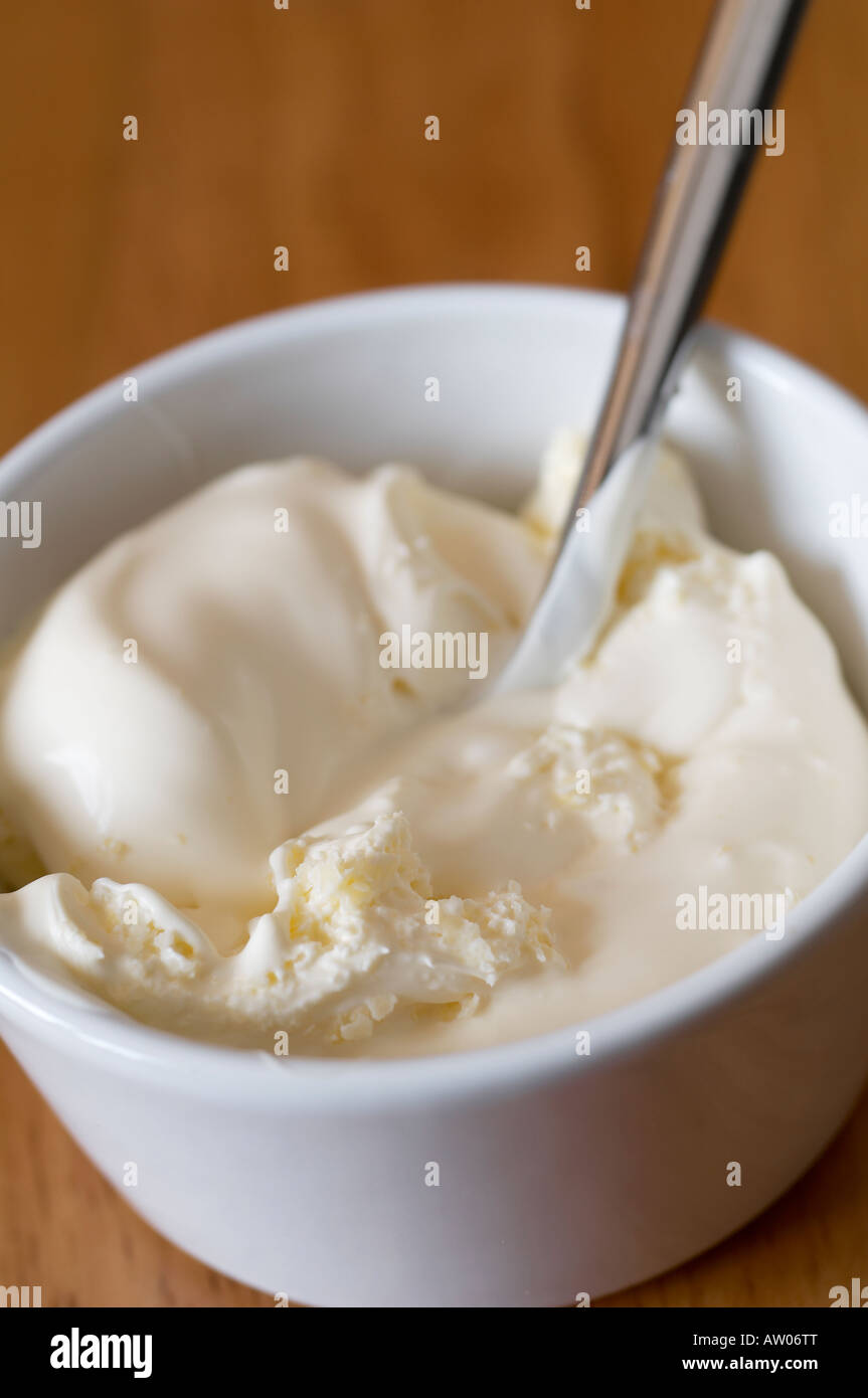 Clotted cream in small pot with teaspoon Stock Photo Alamy