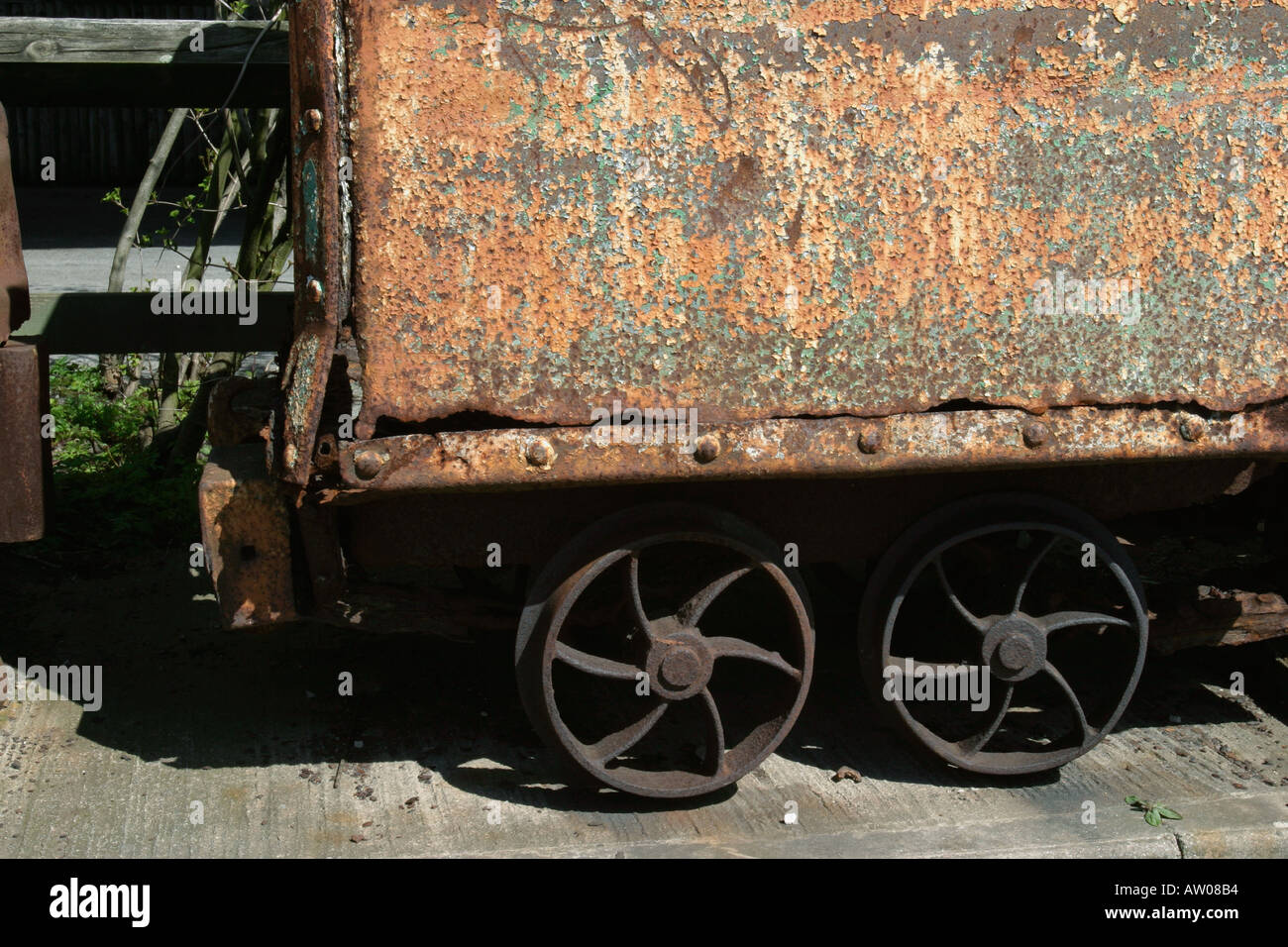 Close up of rusting coal wagon at NCM Body rusted through Rivets and cast iron wheels clearly visible Stock Photo