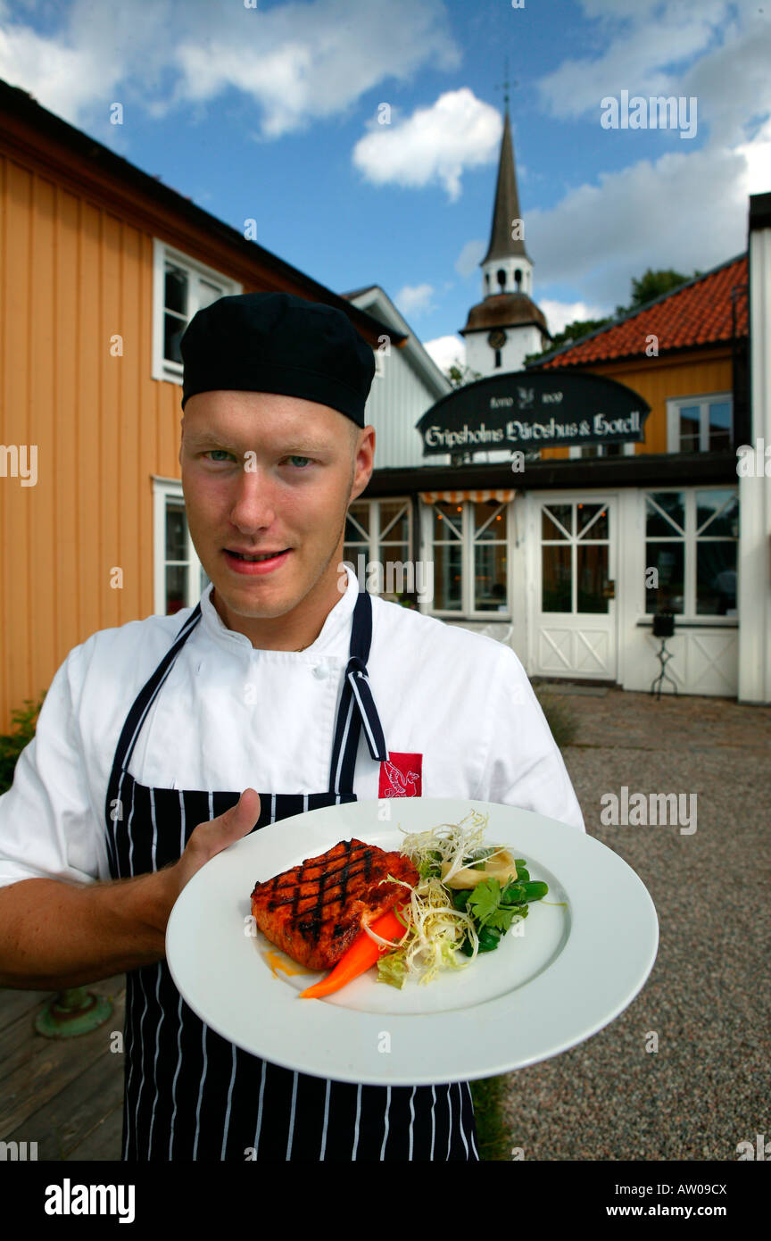 Chef holding dinner plate, restaurant,  Gripsholm kastalinn, Mariefred Sweden Stock Photo