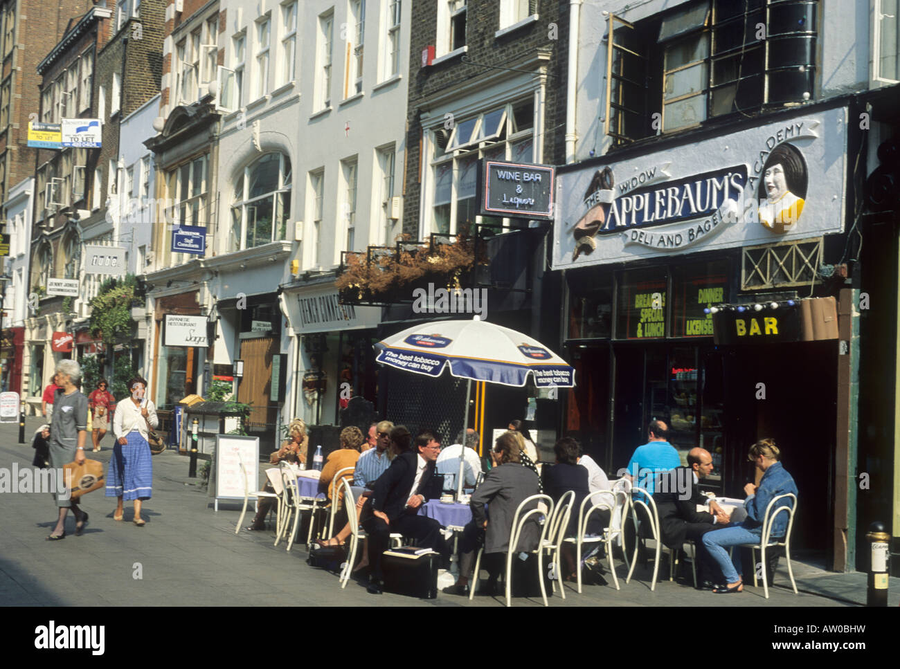 South Moulton Street Mayfair pavement cafe London England UK sunshade umbrella people eating Stock Photo