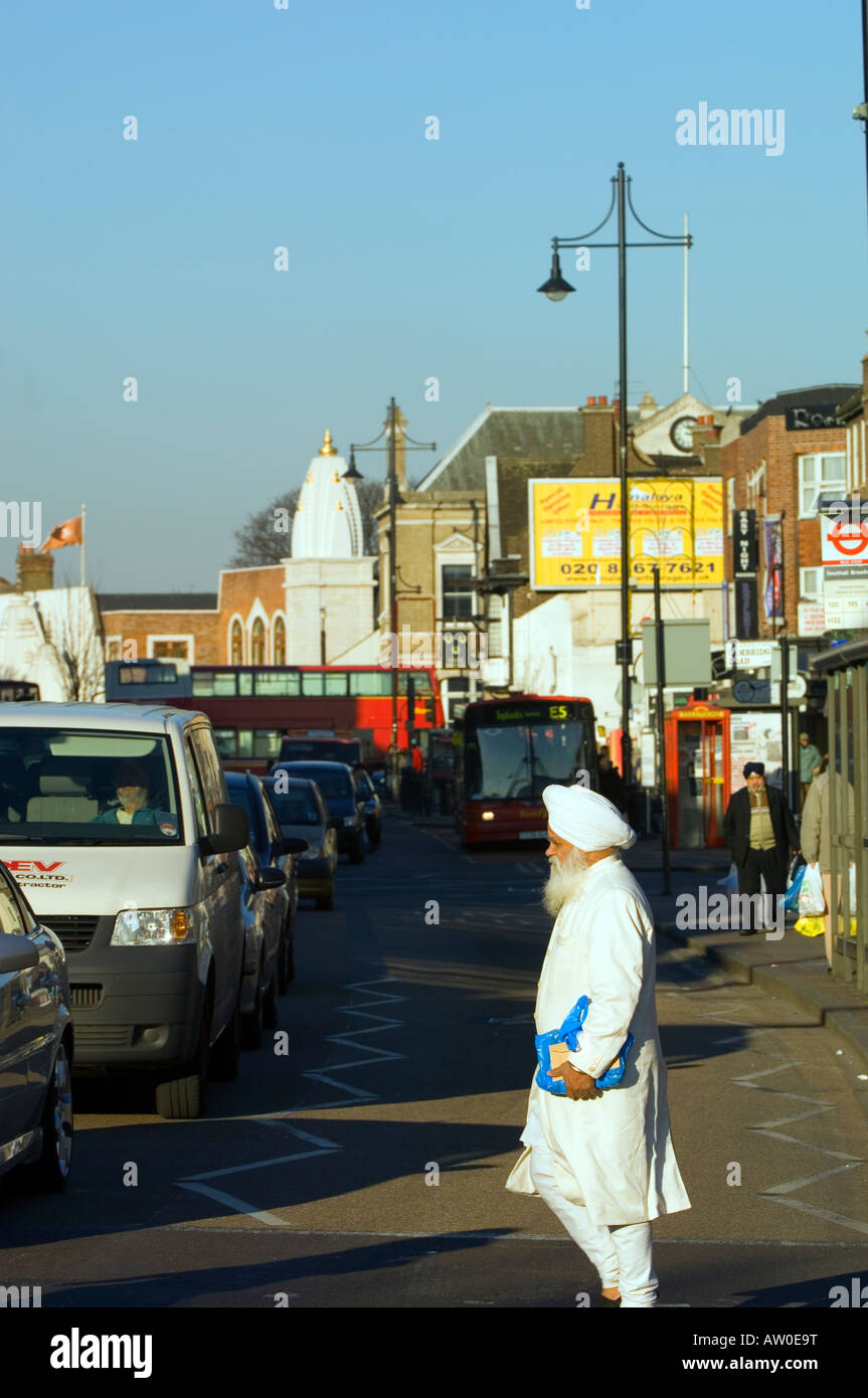 Street traffic and local people Southall London United Kingdom Stock Photo