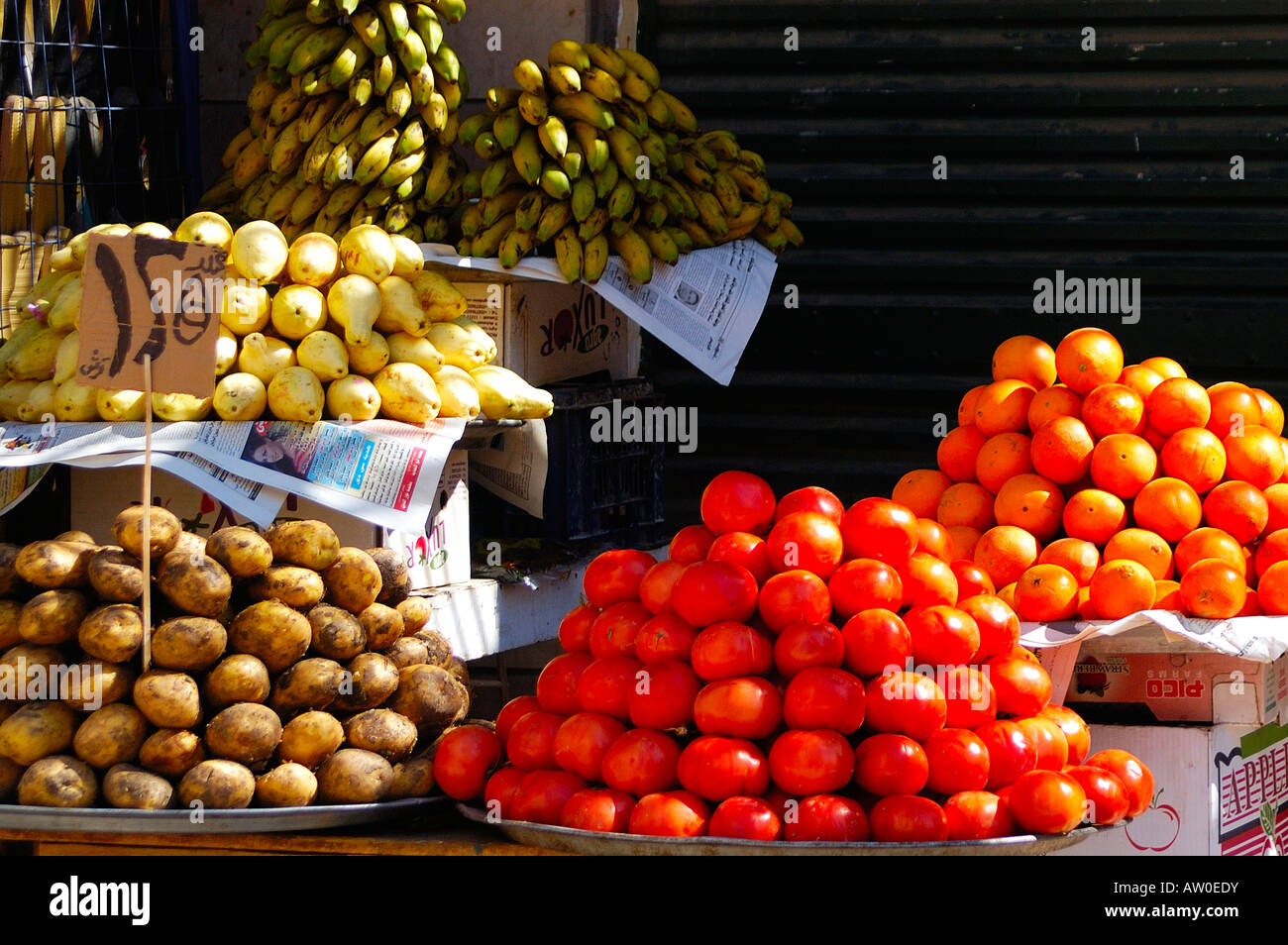 Market stall with fruit  and vegetables stacked on trays and boxes  In Aswan's famous Souq, Egypt Stock Photo