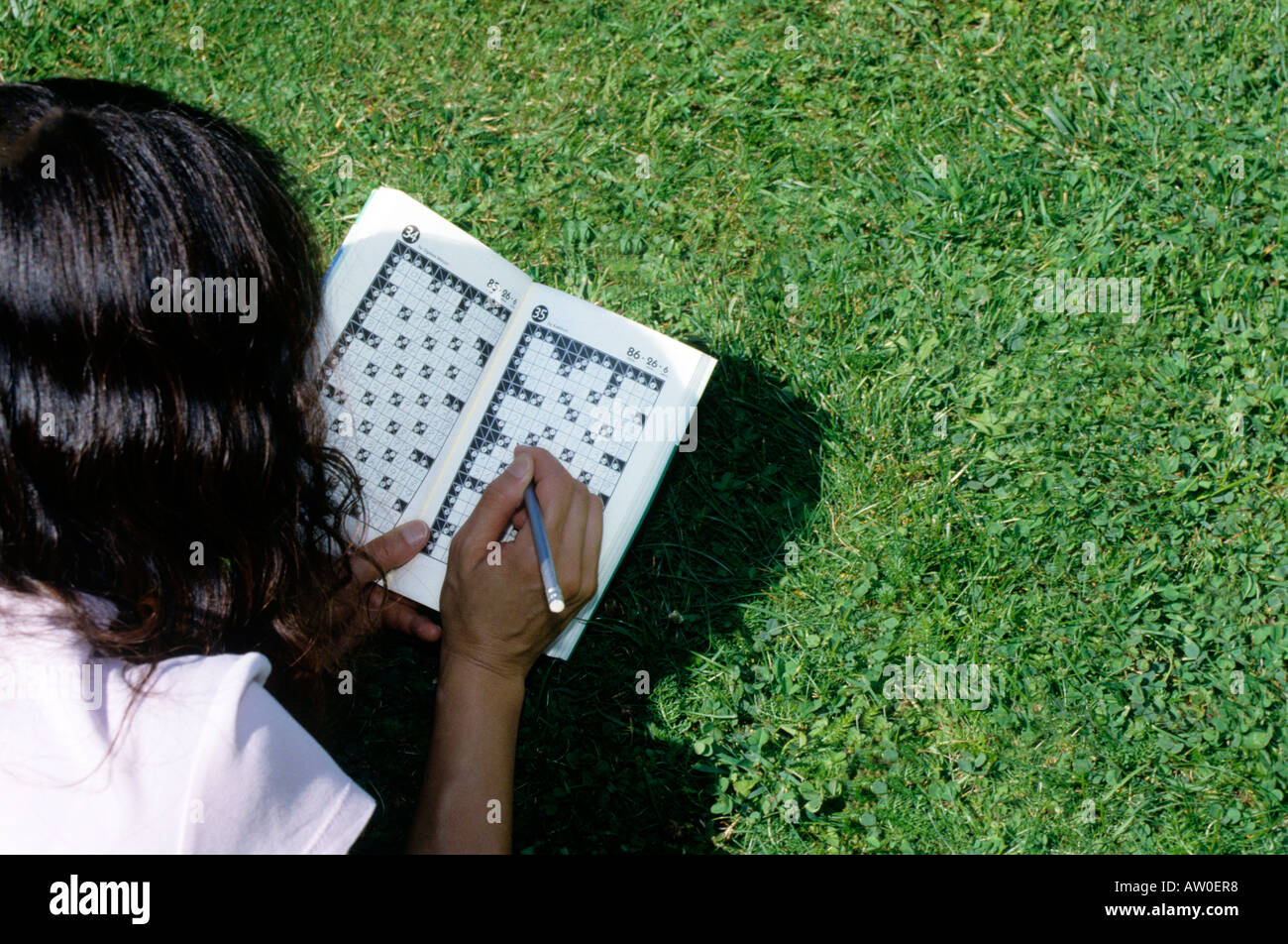 rear view of woman solving kakuro crossword Stock Photo Alamy