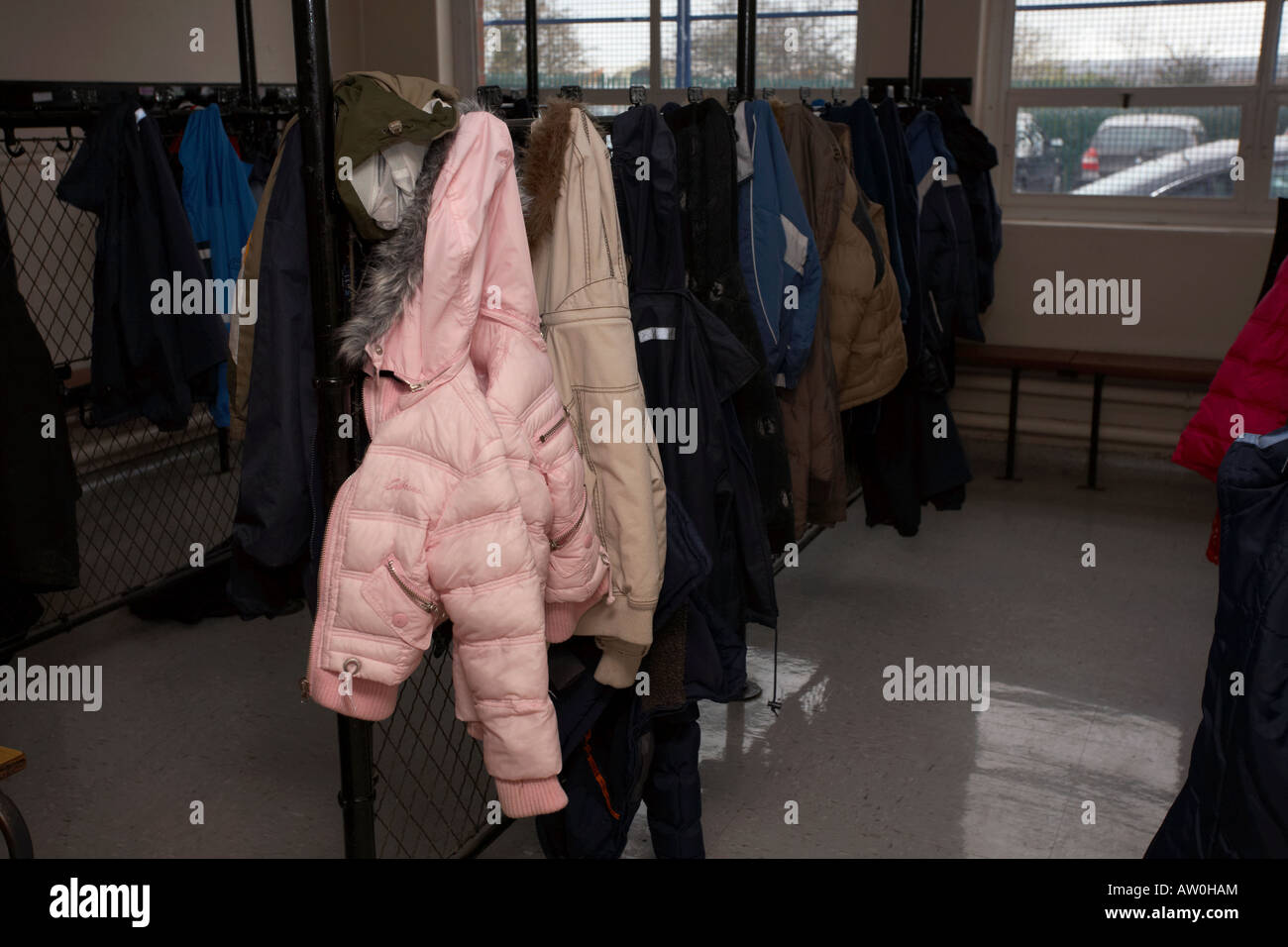 primary school childrens coats hang in the school cloakroom belfast northern ireland uk Stock Photo