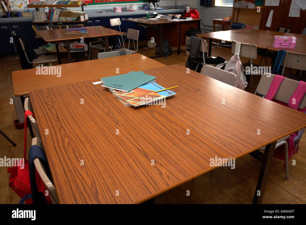 schoolbooks and english textbooks sitting on tables in an empty primary