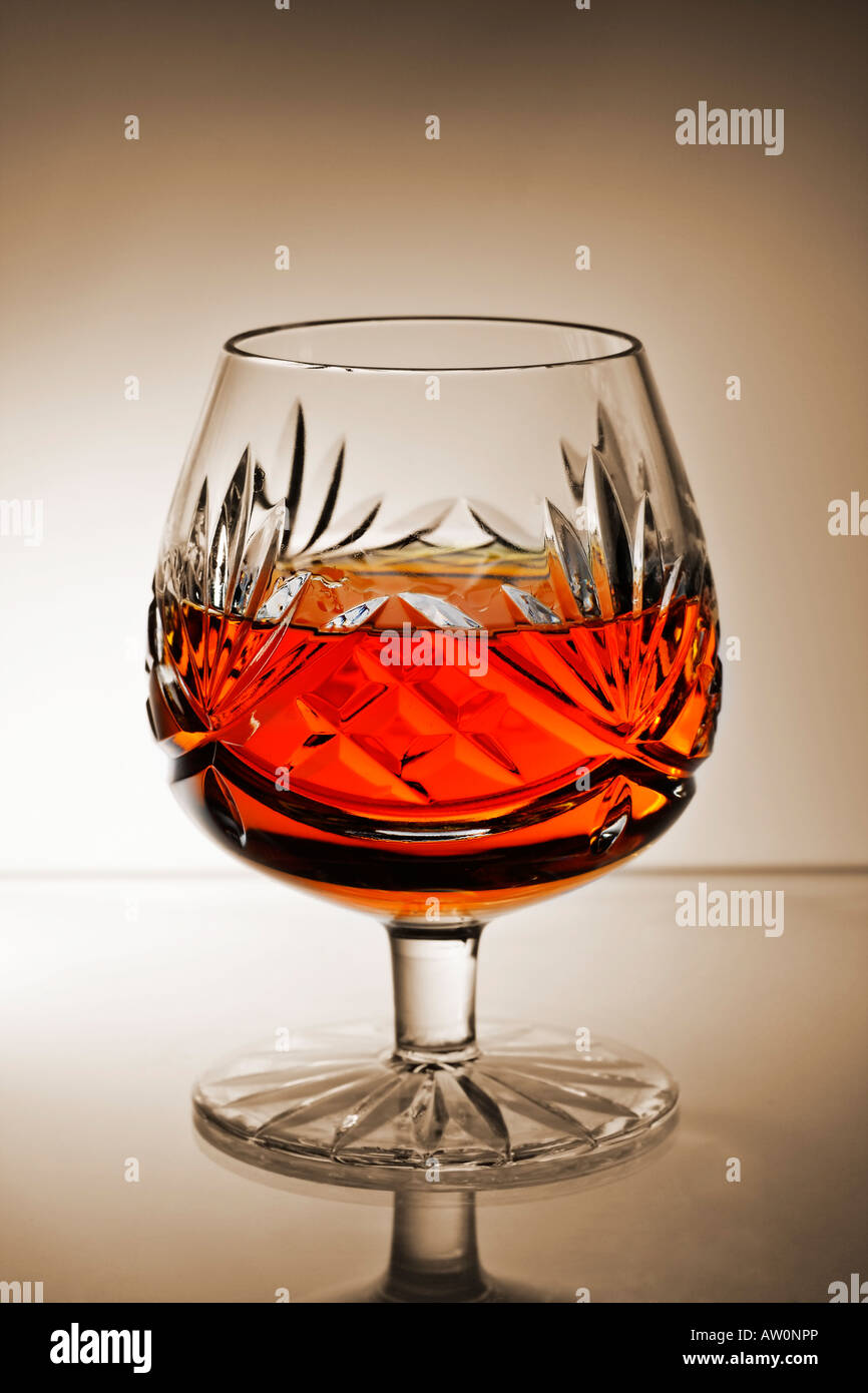 brandy snifter glass with gradient sepia background Stock Photo Alamy