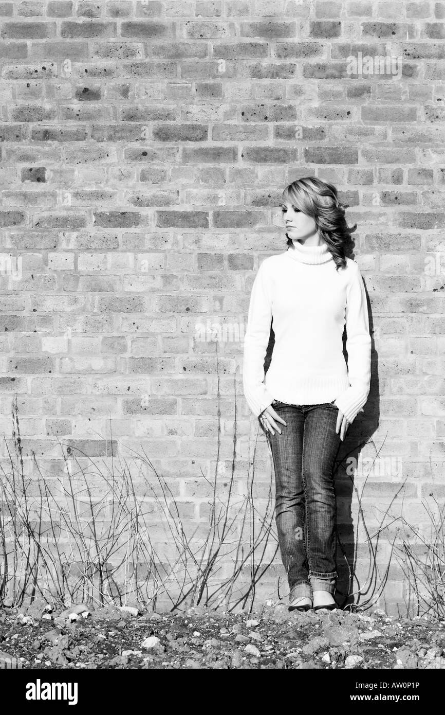 beautiful teen girl standing against a derelict wall Stock Photo