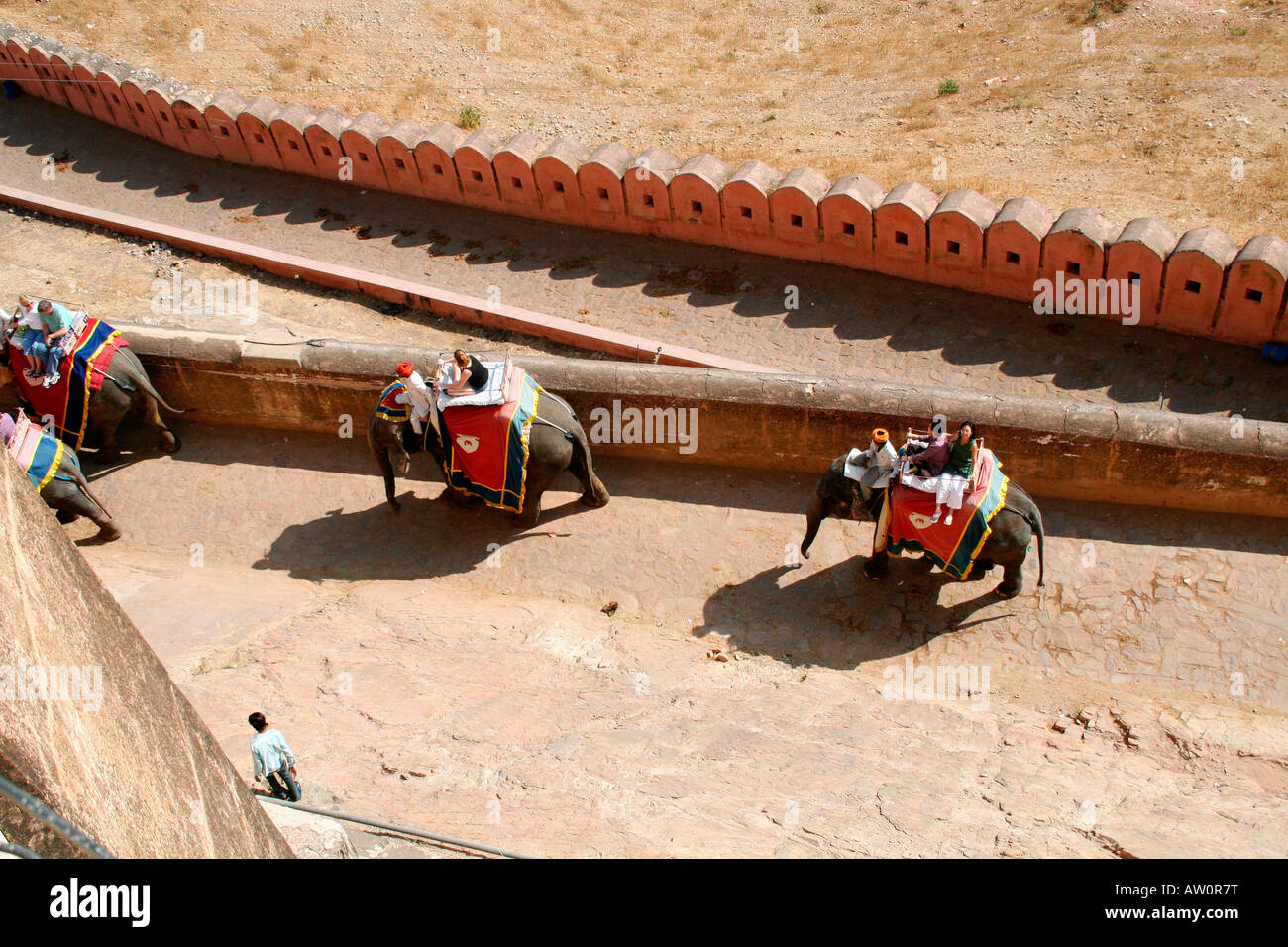 Tourists enjoy elephant rides at Amber Fort near Jaipur Rajasthan -viewed from the main courtyard Stock Photo