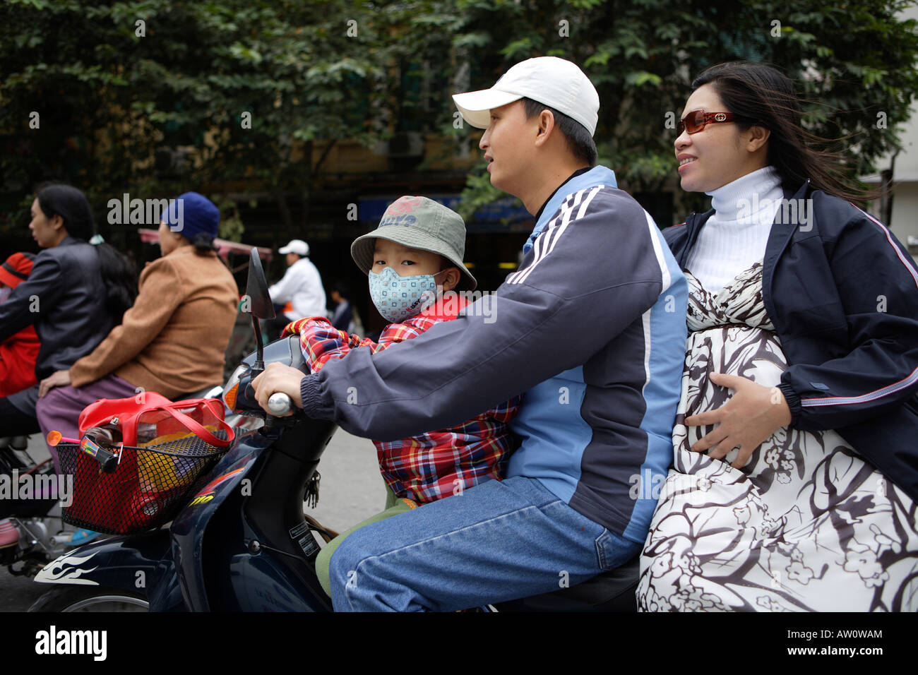 Family on Scooter in Traffic Hanoi North Vietnam Stock Photo