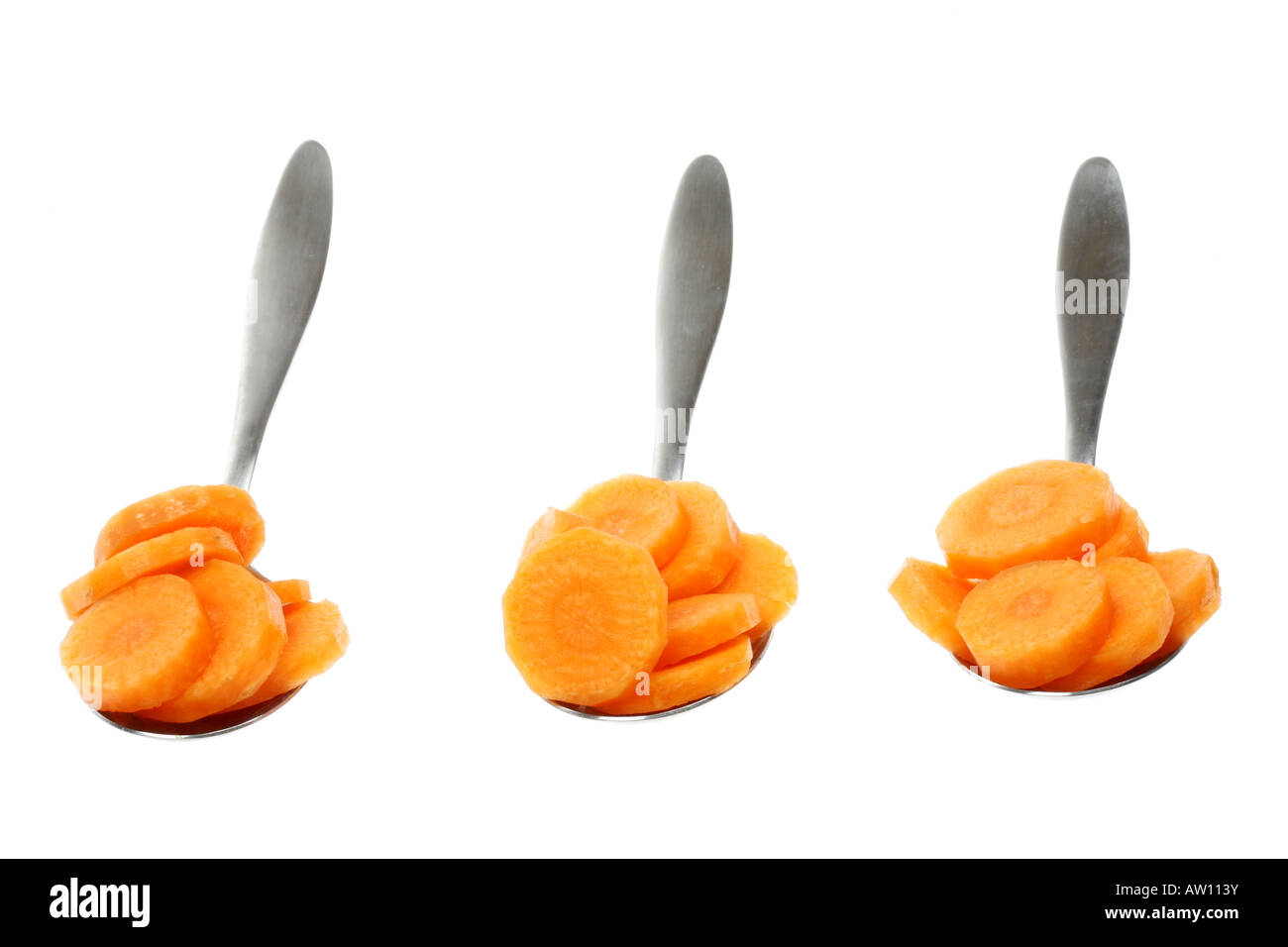 Spoonfuls Of Fresh Ripe Healthy Raw Uncooked Sliced Carrots Isolated White Background With No People And A Clipping Path Stock Photo