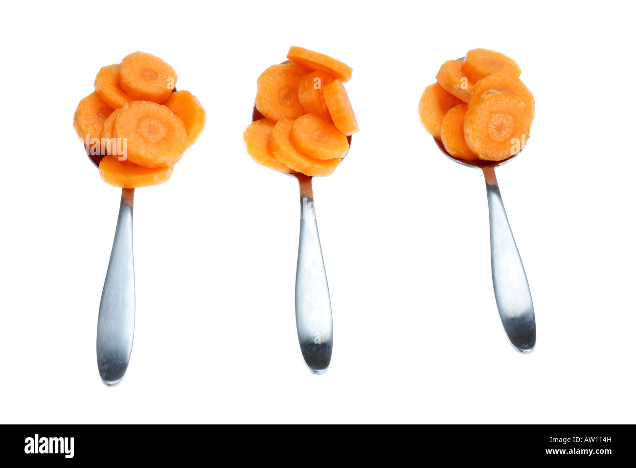 Spoonfuls Of Fresh Ripe Healthy Raw Uncooked Sliced Carrots Isolated White Background With No People And A Clipping Path Stock Photo