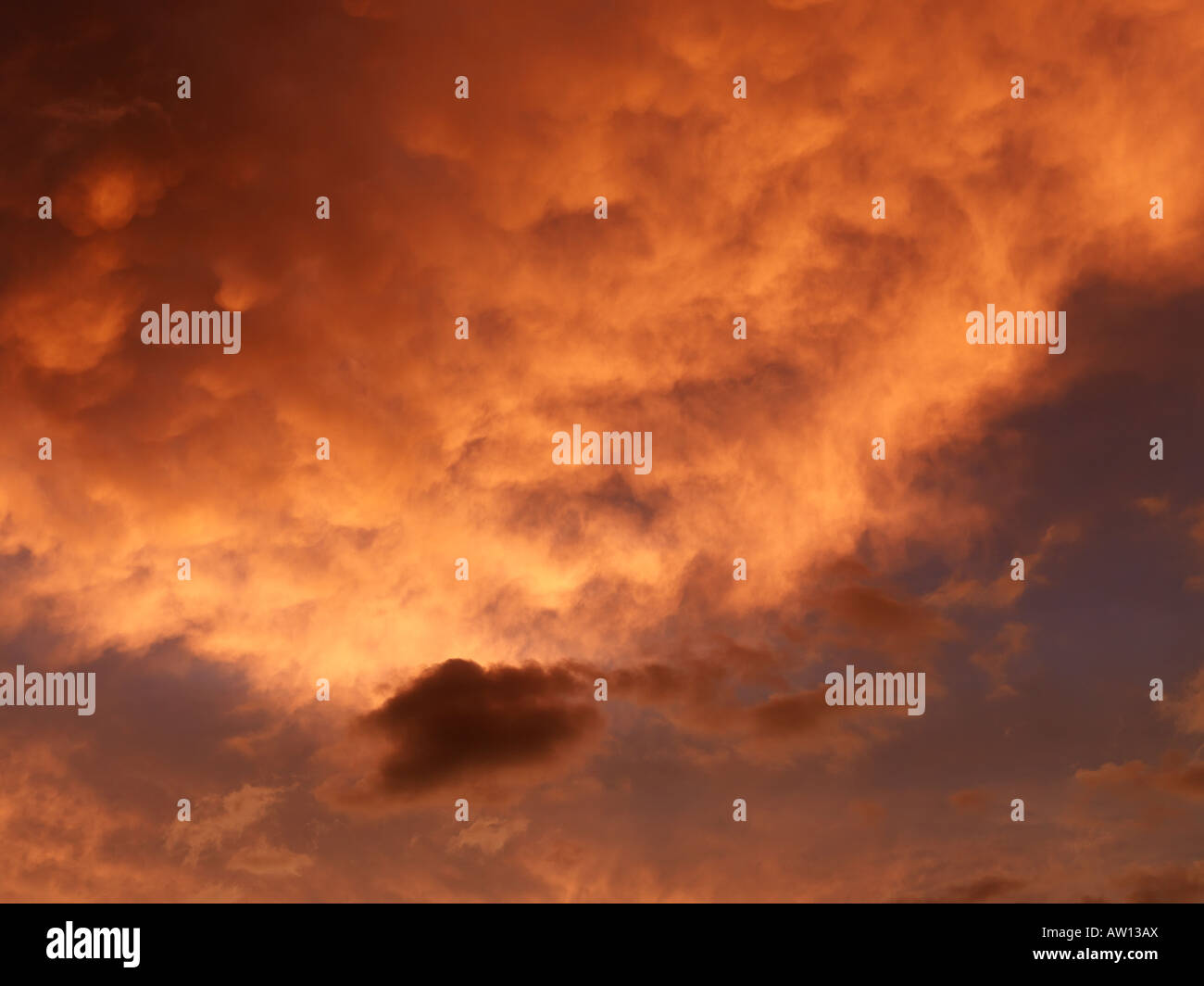 Sunset sky with orange and yellow clouds Stock Photo