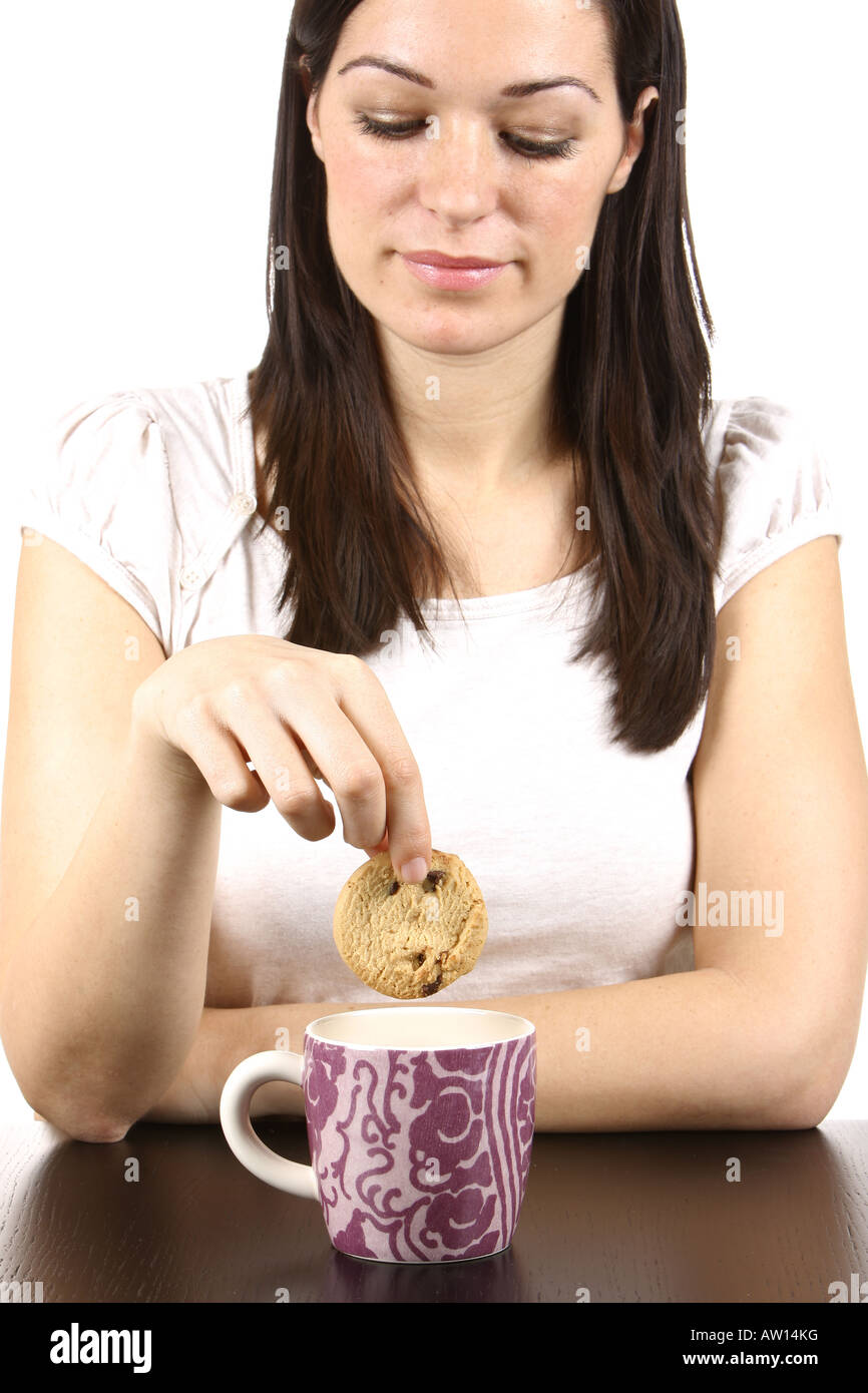 Young Woman Dipping Cookie in Tea Model Released Stock Photo Alamy