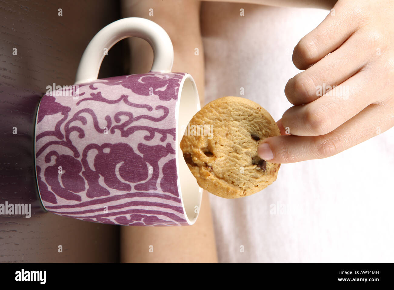 Young Woman Dipping Cookie in Tea Model Released Stock Photo Alamy