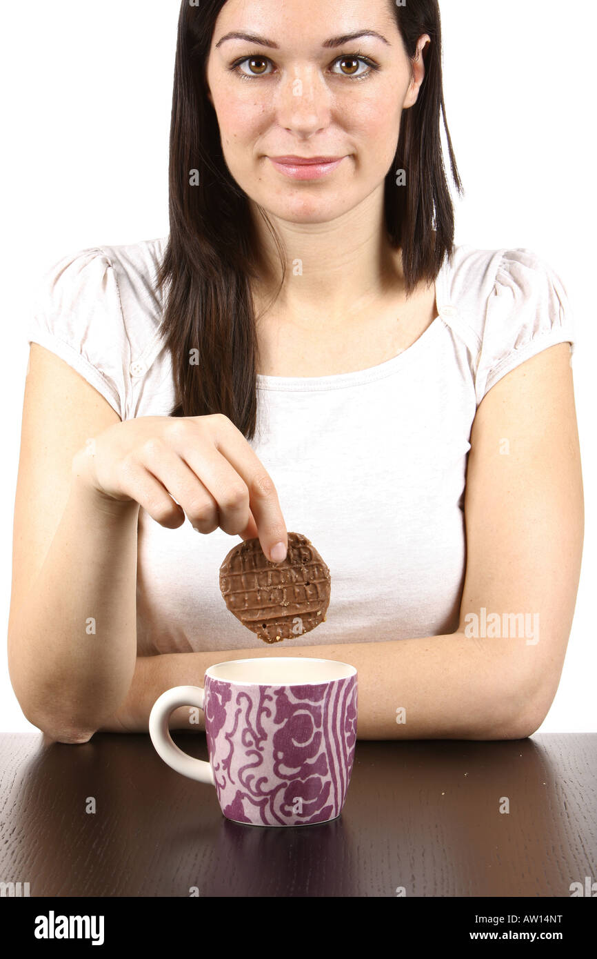 Young Woman Dipping Cookie in Tea Model Released Stock Photo Alamy
